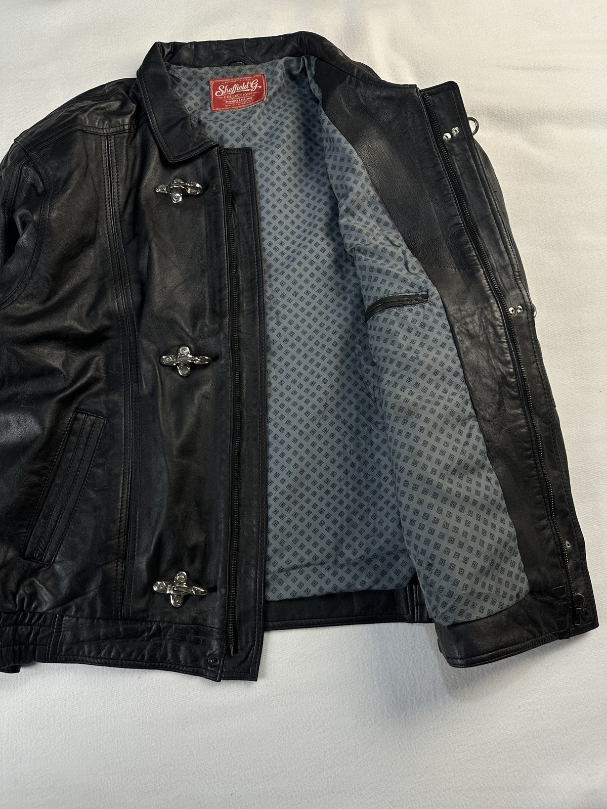 Black leather vintage jacket, size L - cuff and hem detail.