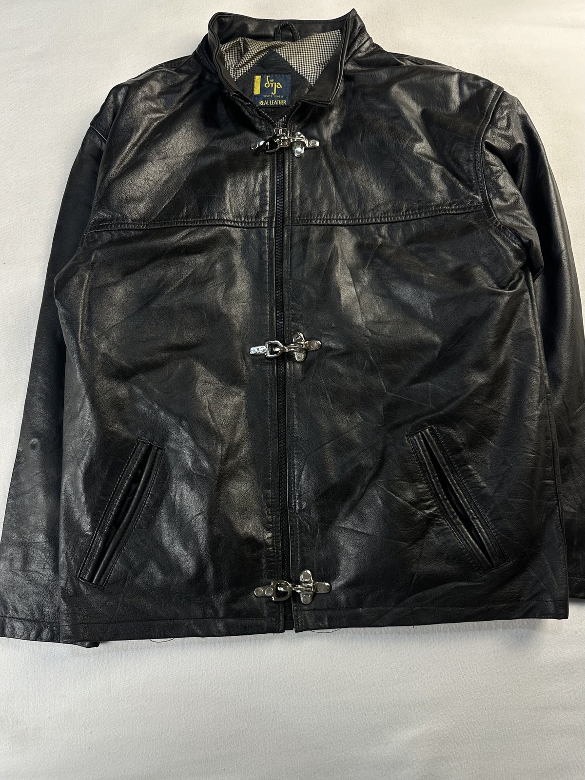 Black leather cafe racer jacket, size L - chest and pocket detail.