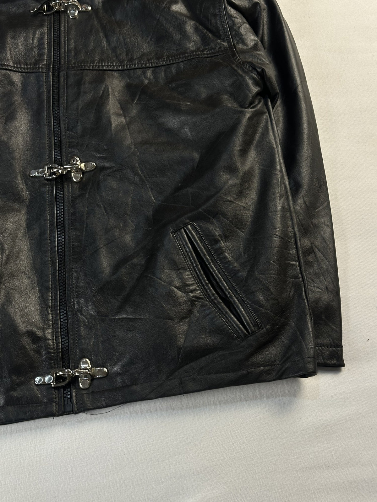 Black leather cafe racer jacket, size L - size and label context.