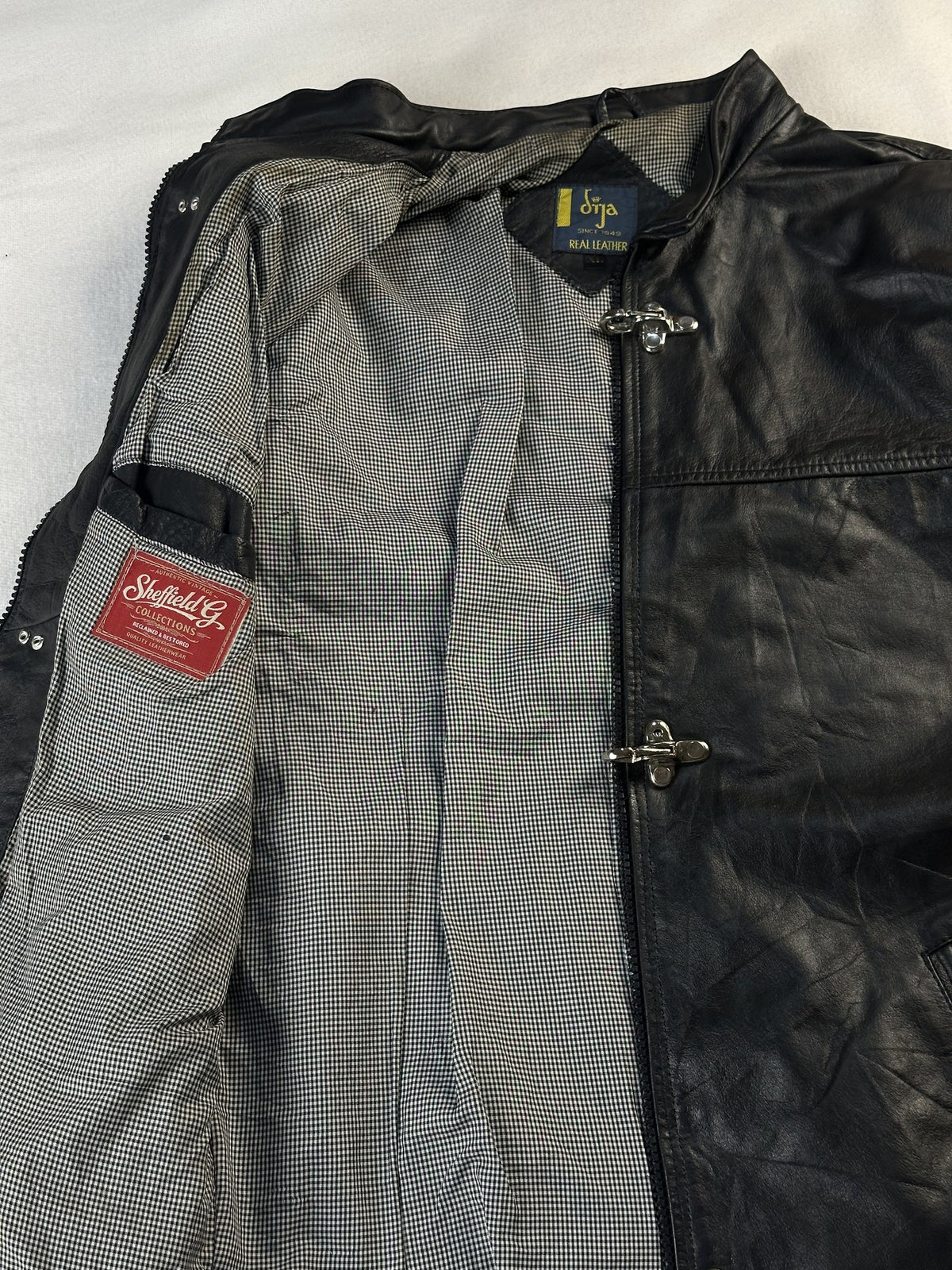 Black leather cafe racer jacket, size L - cuff and hem detail.