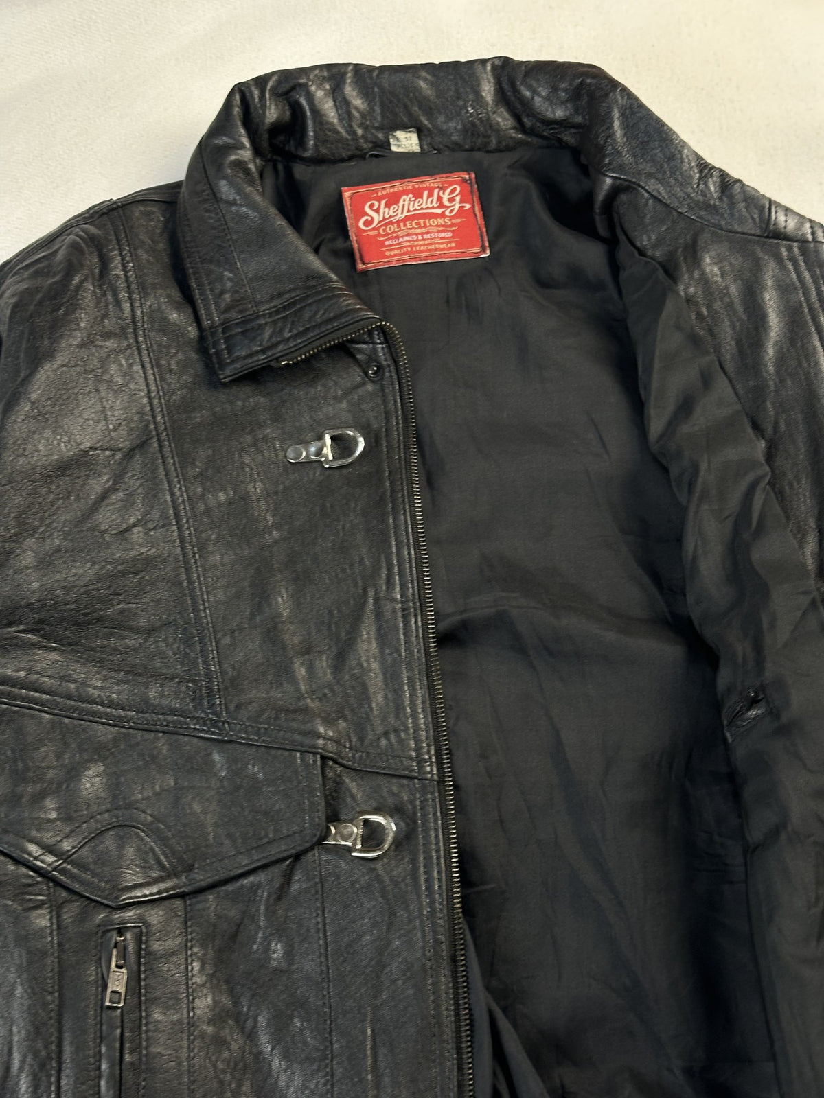 Black leather vintage jacket, size M - cuff and hem detail.