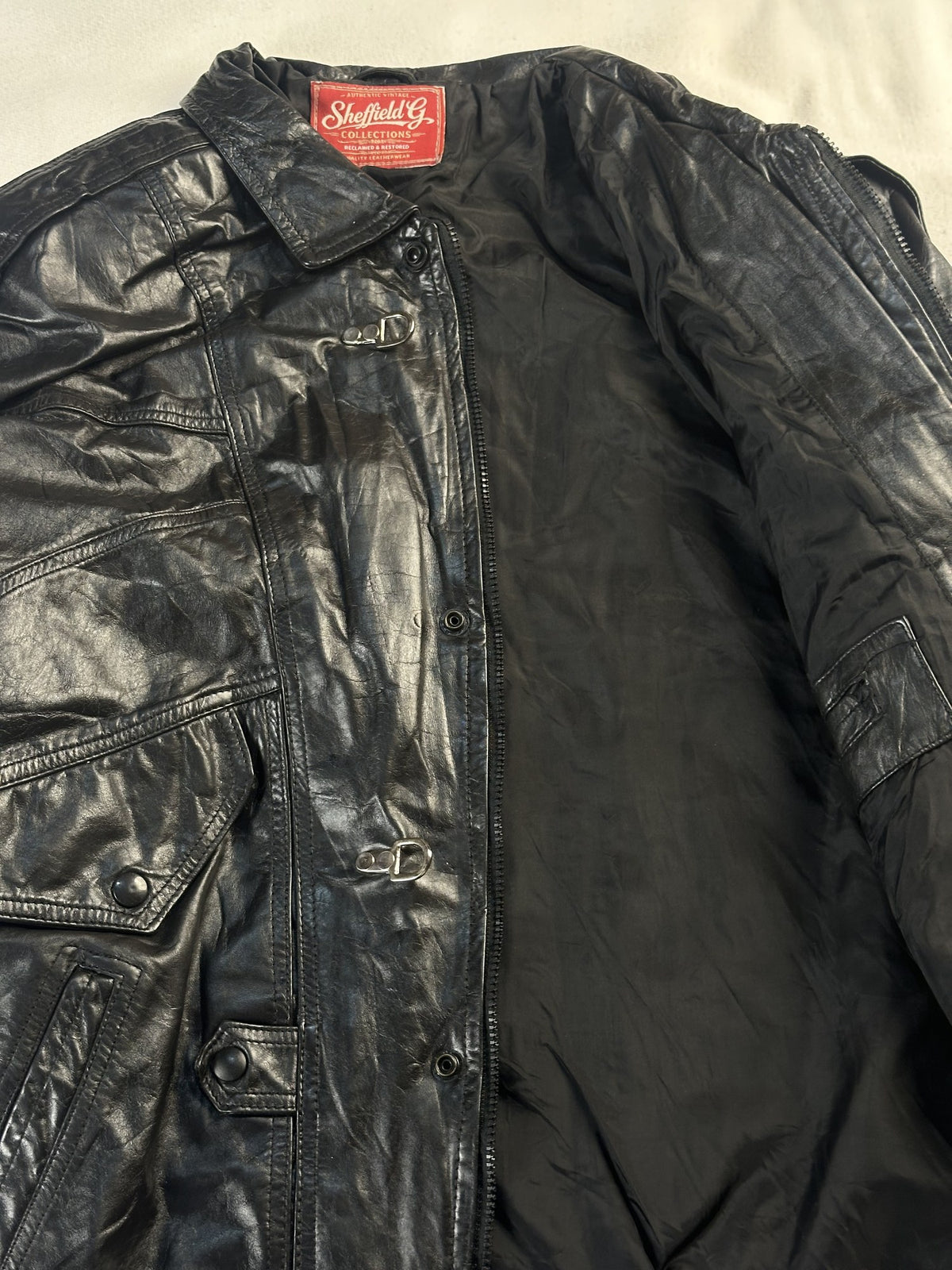 Black leather vintage jacket, size L - cuff and hem detail.