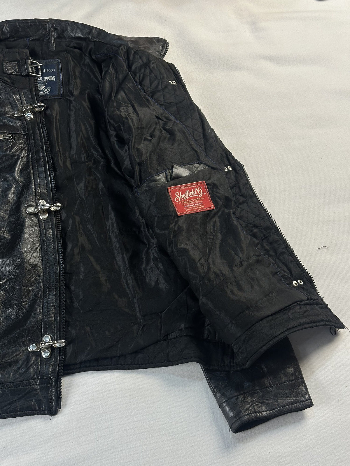 Black leather vintage jacket, size M - cuff and hem detail.