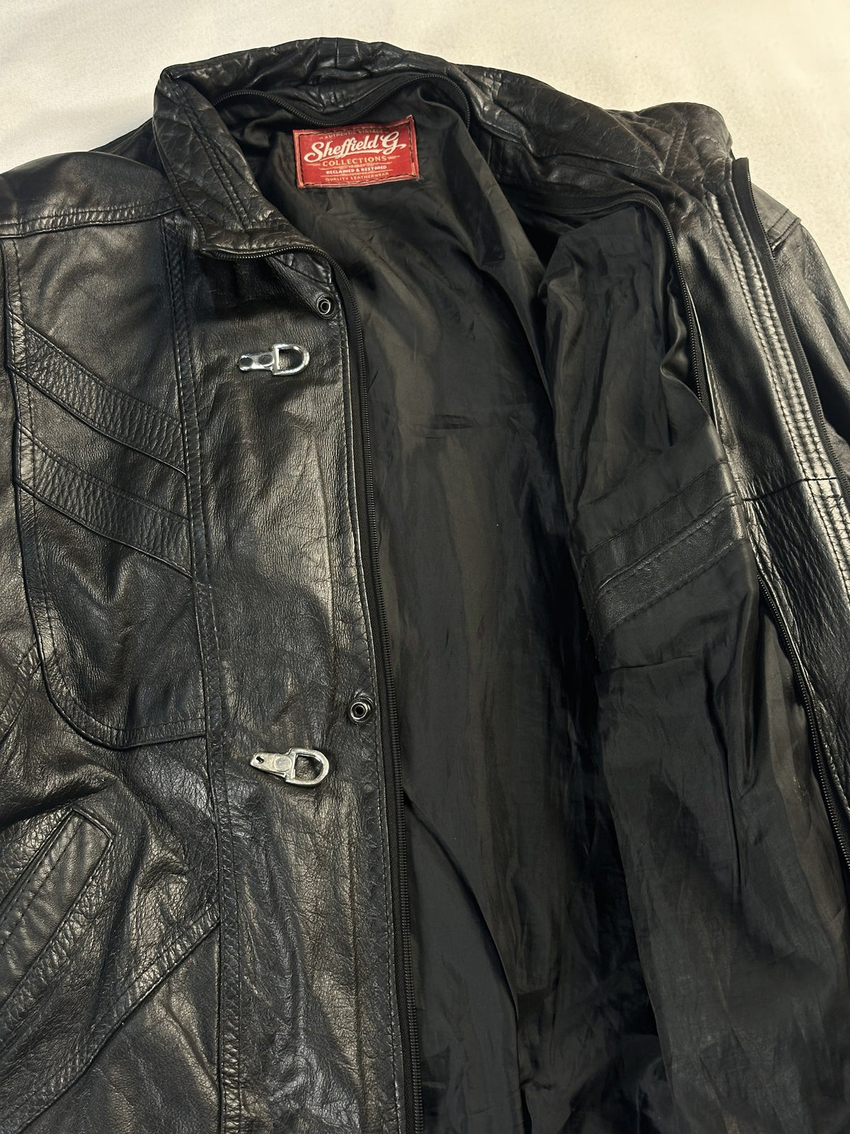 Black leather vintage jacket, size L - cuff and hem detail.