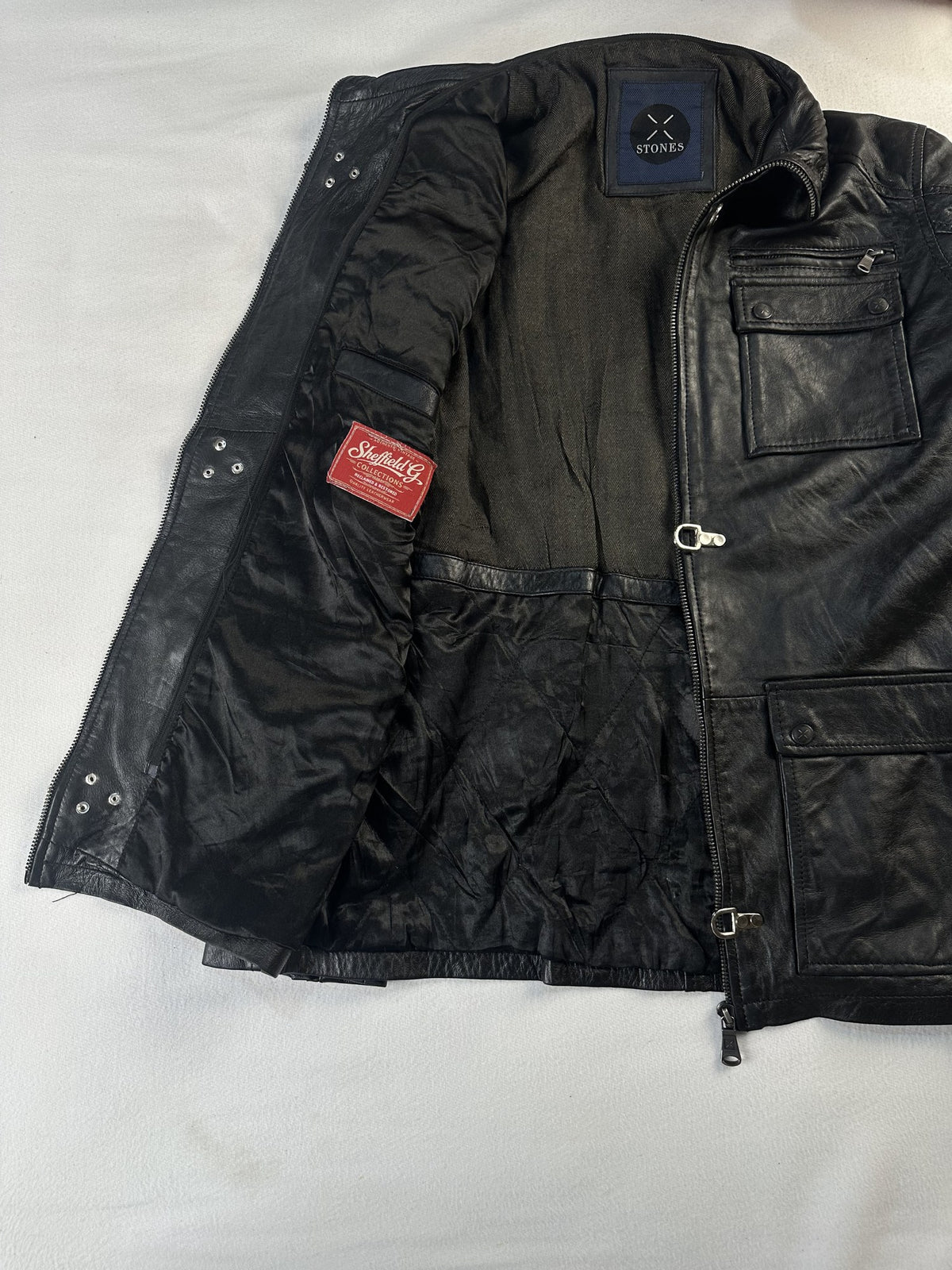 Black leather field jacket, size L - cuff and hem detail.