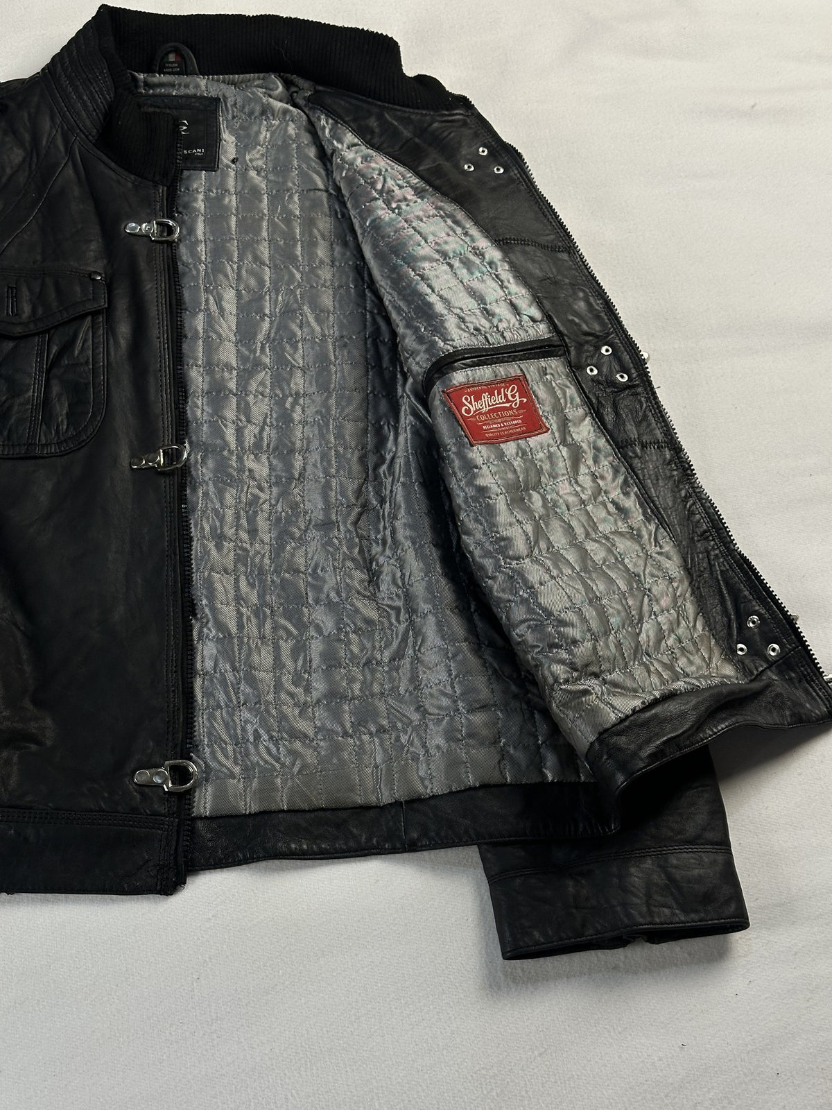 Black leather bomber jacket, size L - cuff and hem detail.