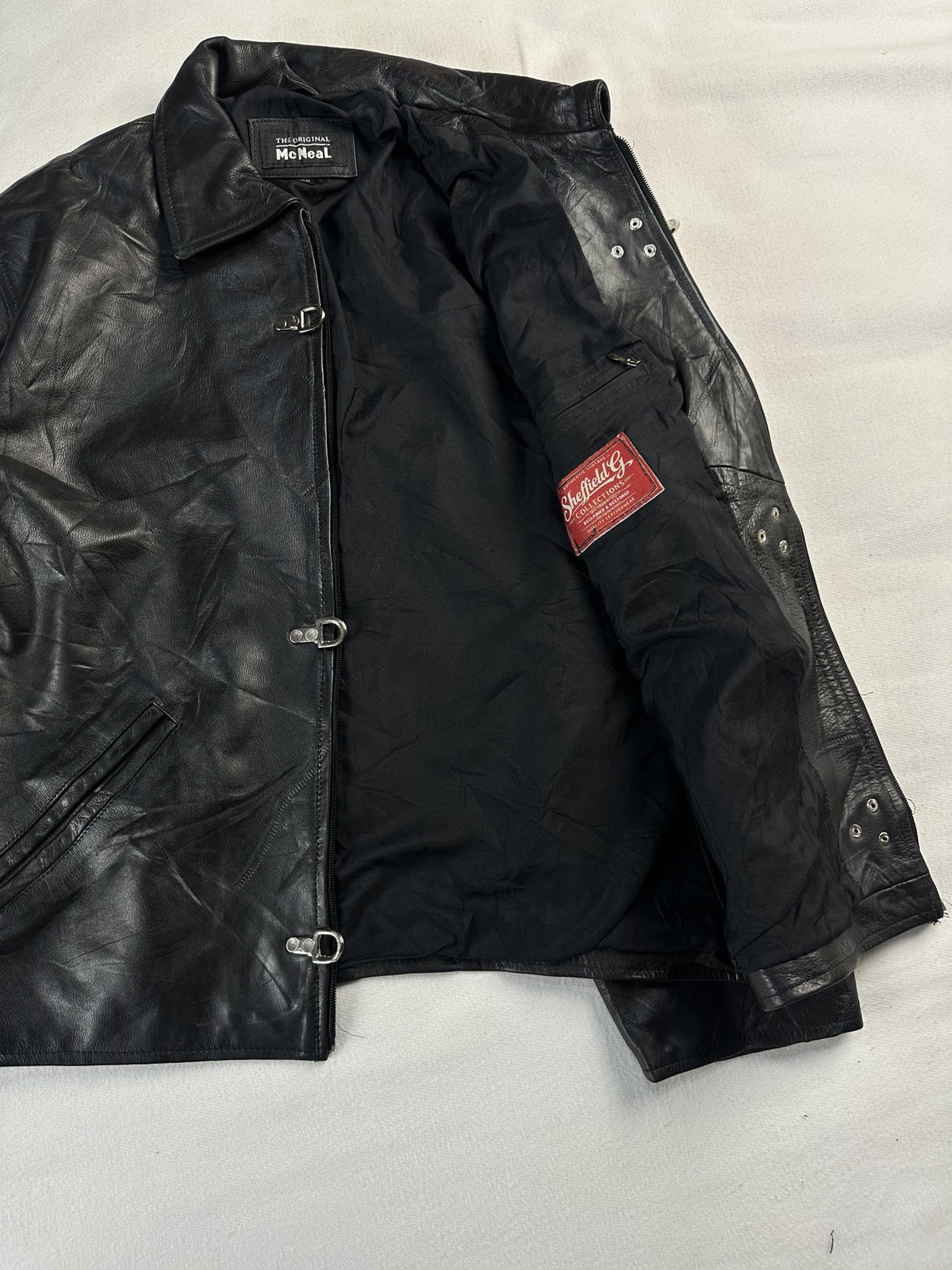 Black leather vintage jacket, size L - cuff and hem detail.