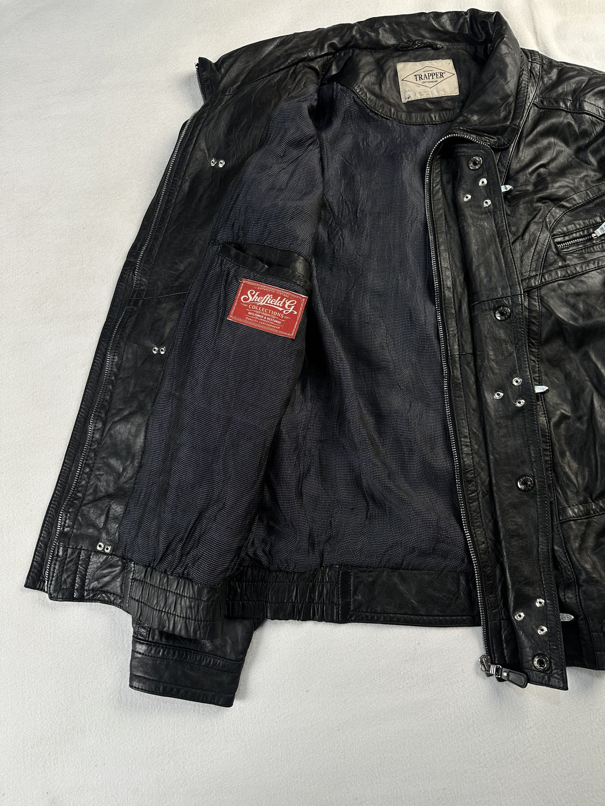 Black leather vintage jacket, size XL - cuff and hem detail.
