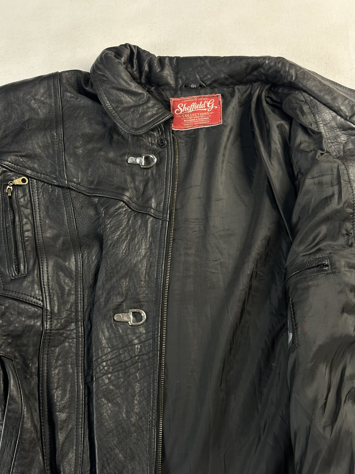 Black leather vintage jacket, size L - cuff and hem detail.