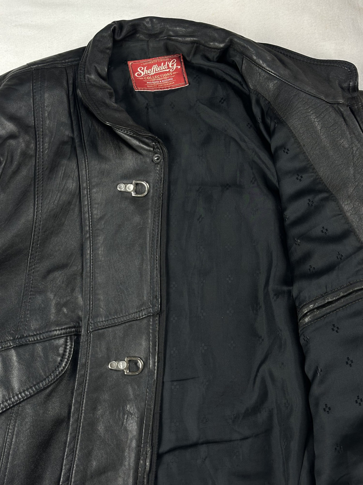 Black leather vintage jacket, size L - cuff and hem detail.