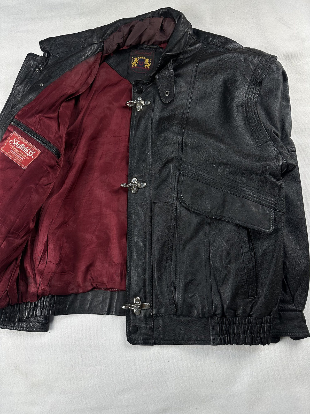 Black leather field jacket, size L - cuff and hem detail.