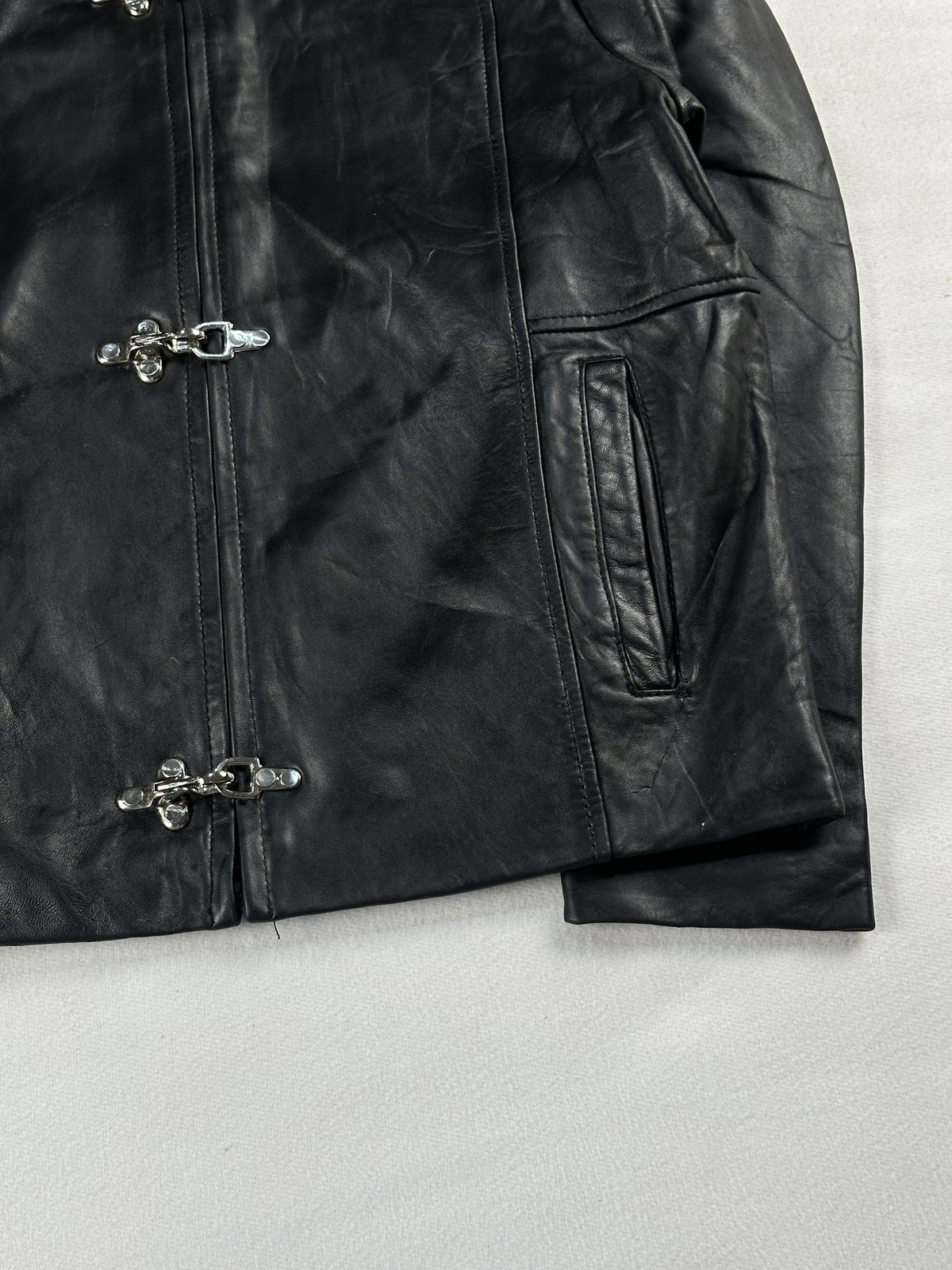 Black leather cafe racer jacket, size M - size and label context.