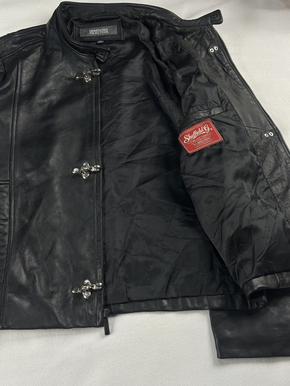 Black leather cafe racer jacket, size M - cuff and hem detail.