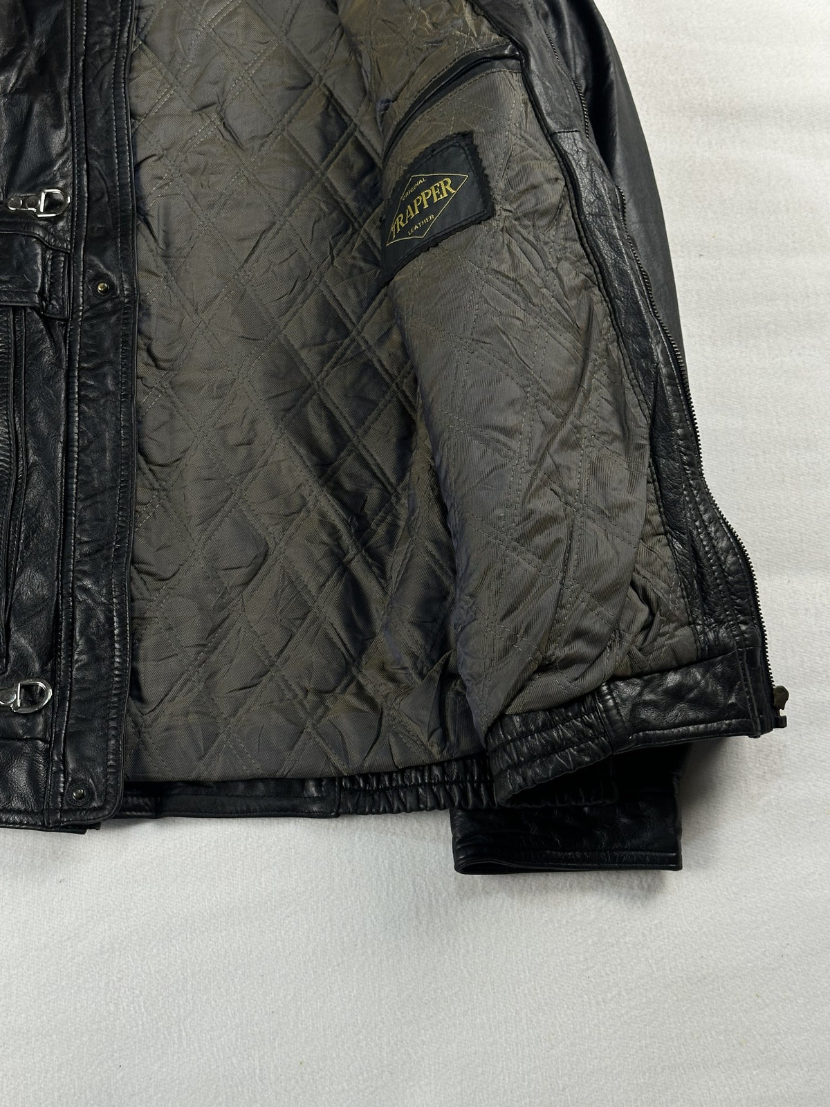 Black leather vintage jacket, size L - cuff and hem detail.