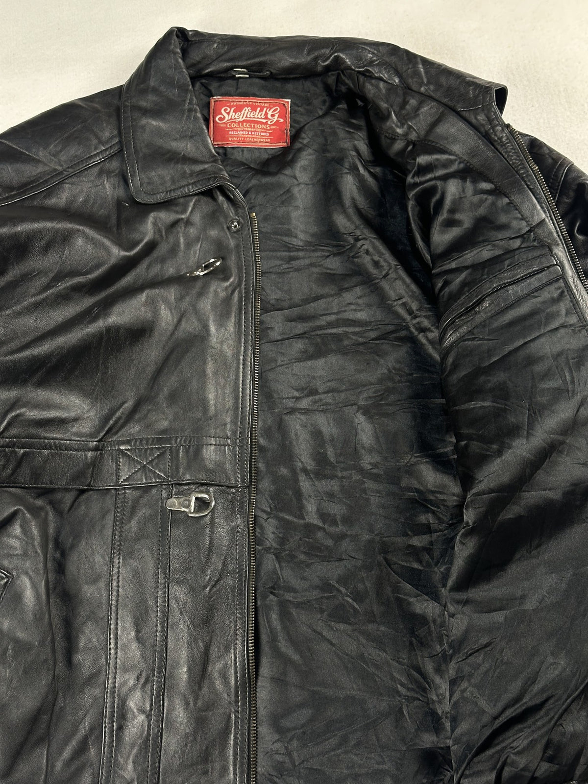 Black leather vintage jacket, size L - cuff and hem detail.