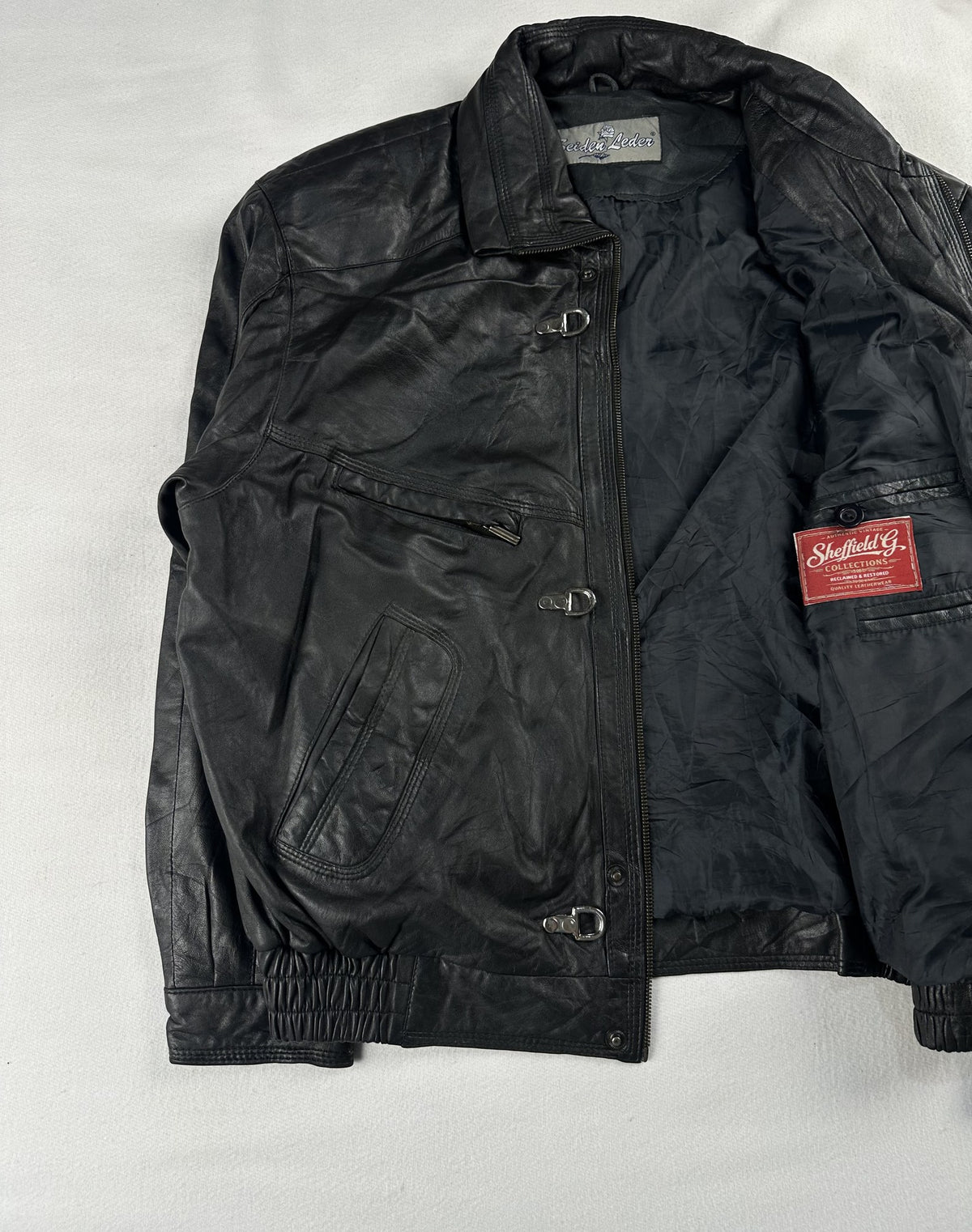 Black leather vintage jacket, size L - cuff and hem detail.