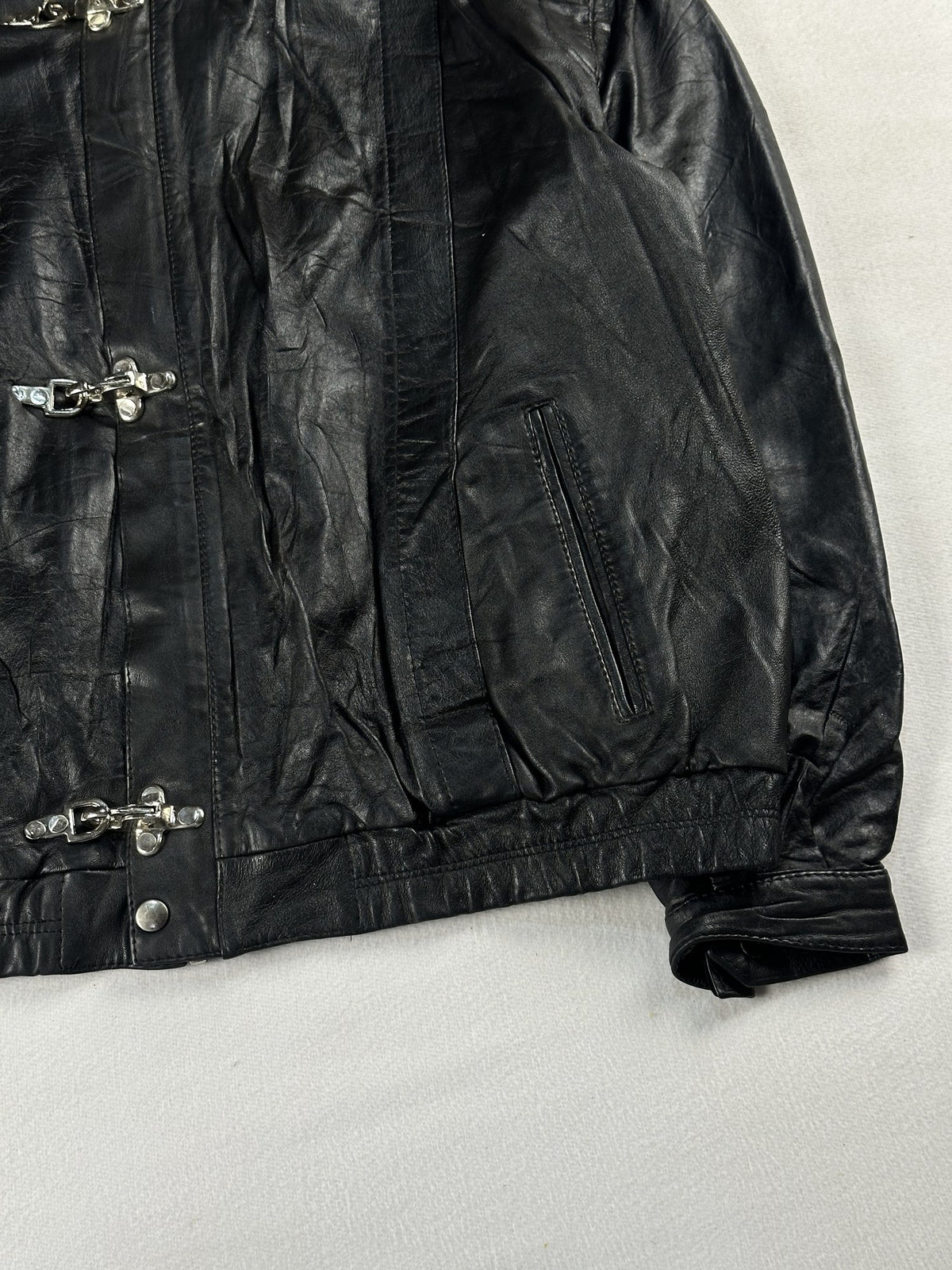 Black leather cafe racer jacket, size L - size and label context.