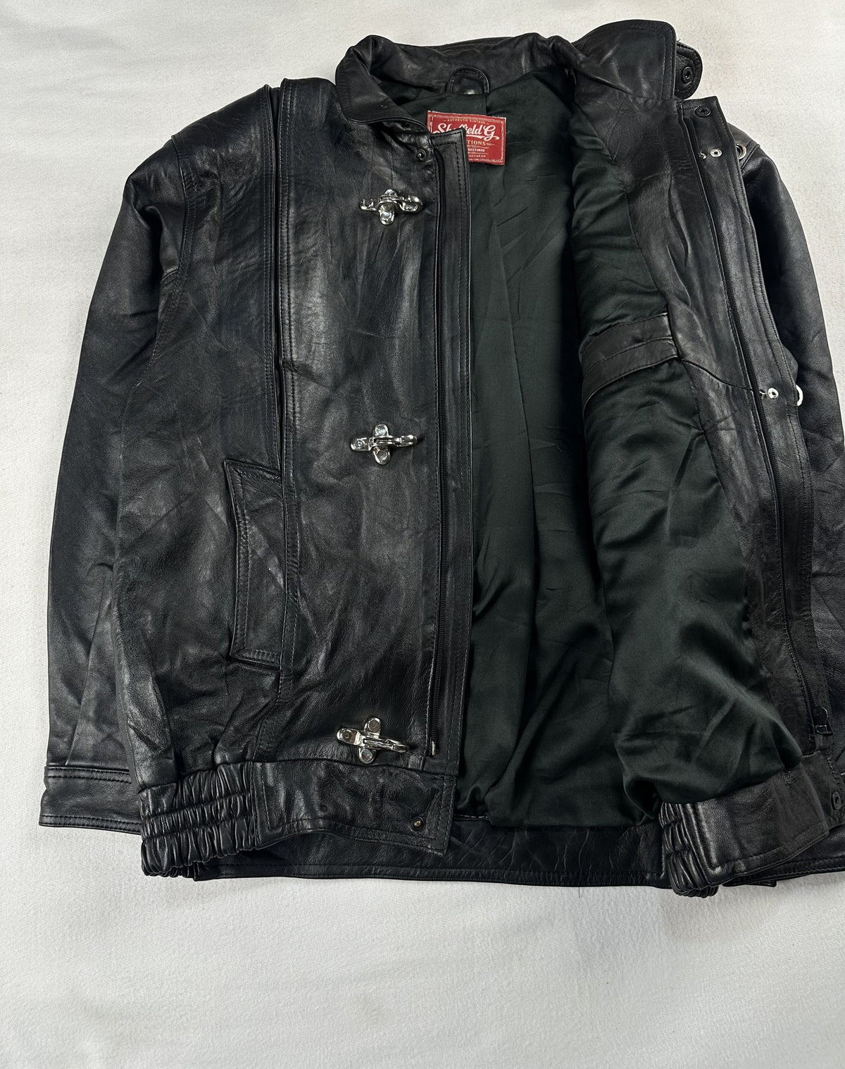 Black leather vintage jacket, size L - cuff and hem detail.