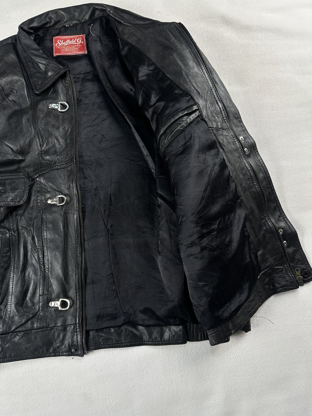 Black leather vintage jacket, size L - cuff and hem detail.