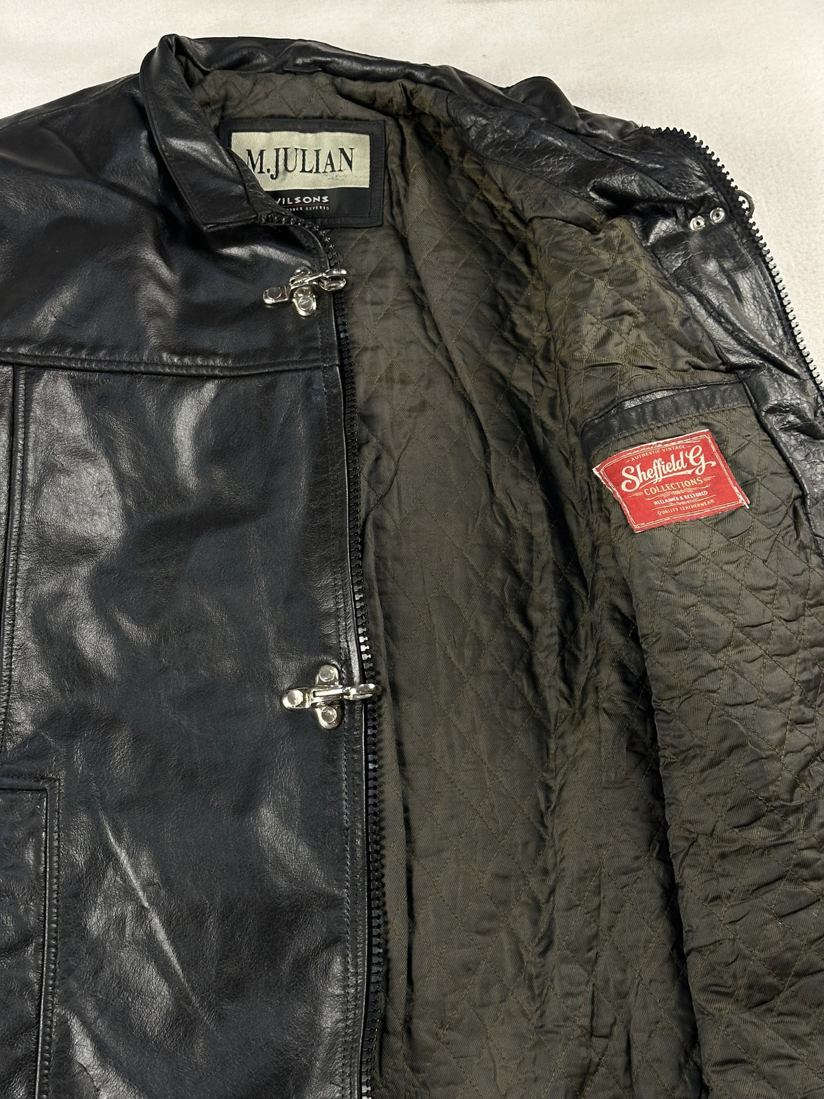 Black leather cafe racer jacket, size M - front closure detail.