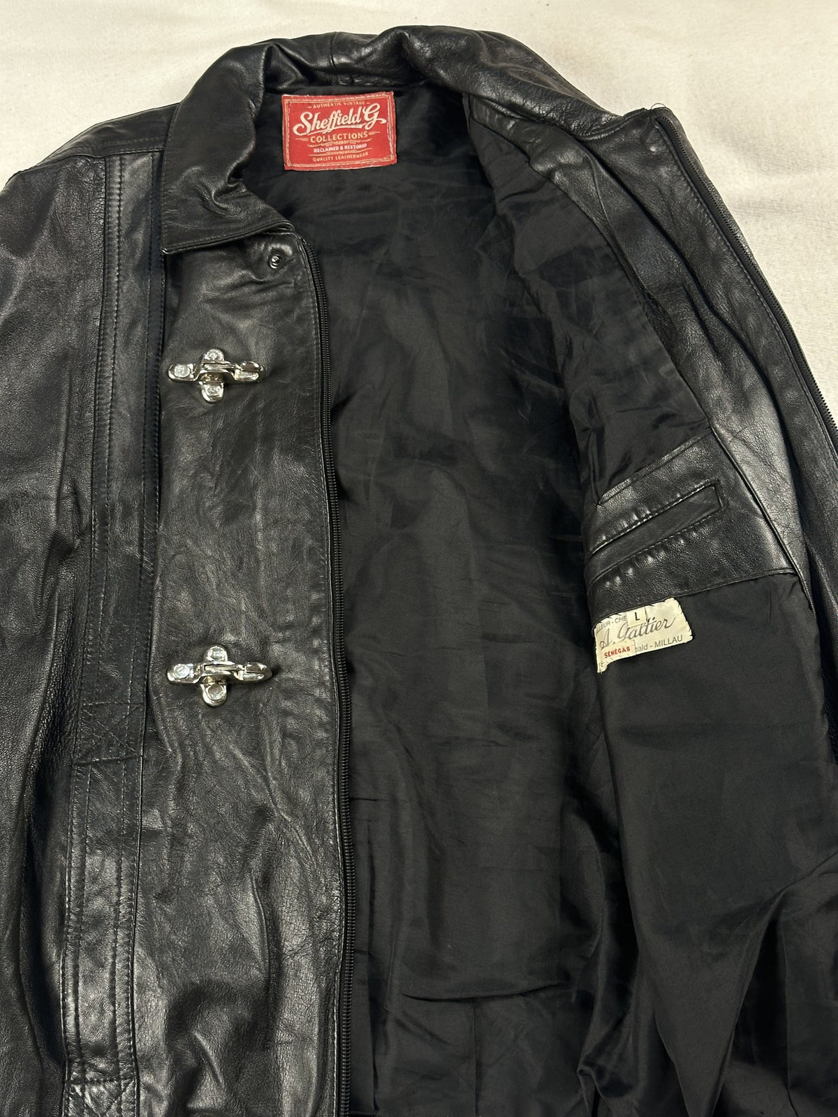 Black leather vintage jacket, size L - cuff and hem detail.