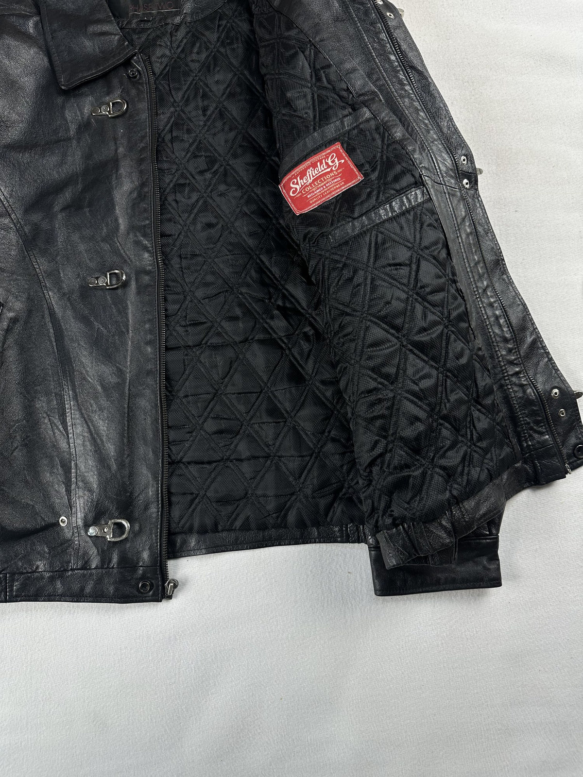 Black leather vintage jacket, size L - cuff and hem detail.