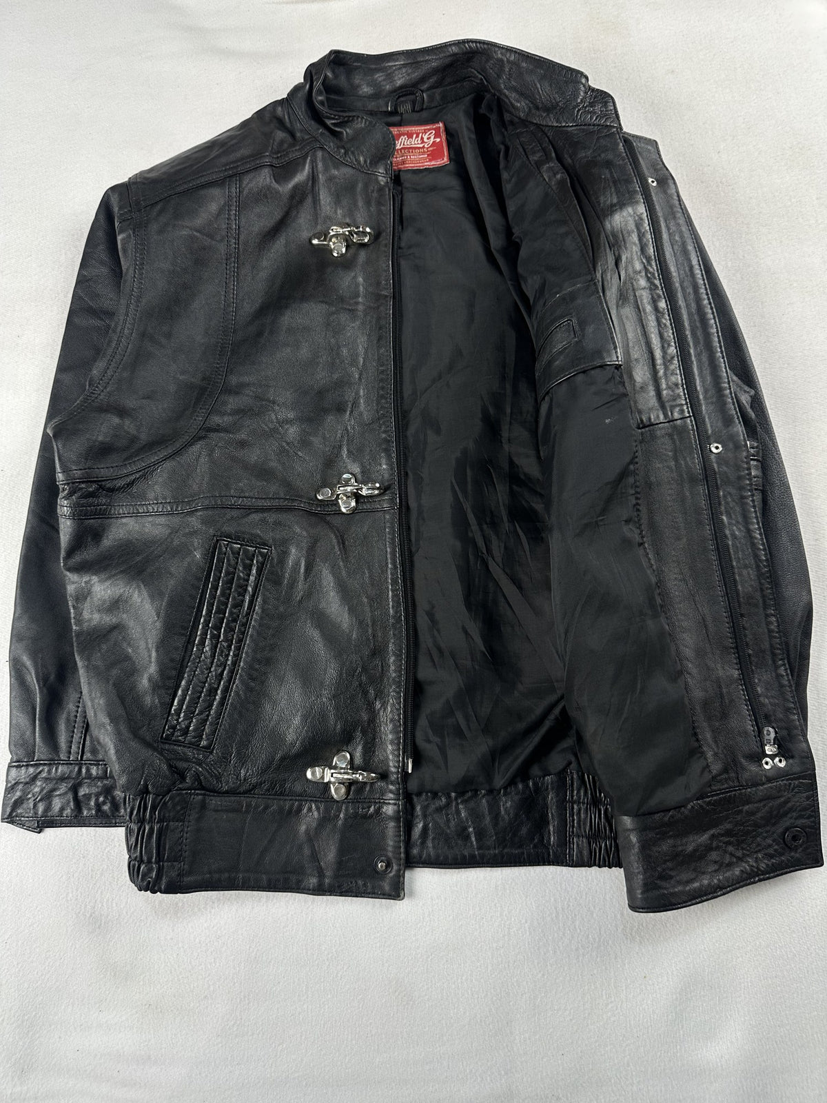 Black leather vintage jacket, size M - cuff and hem detail.