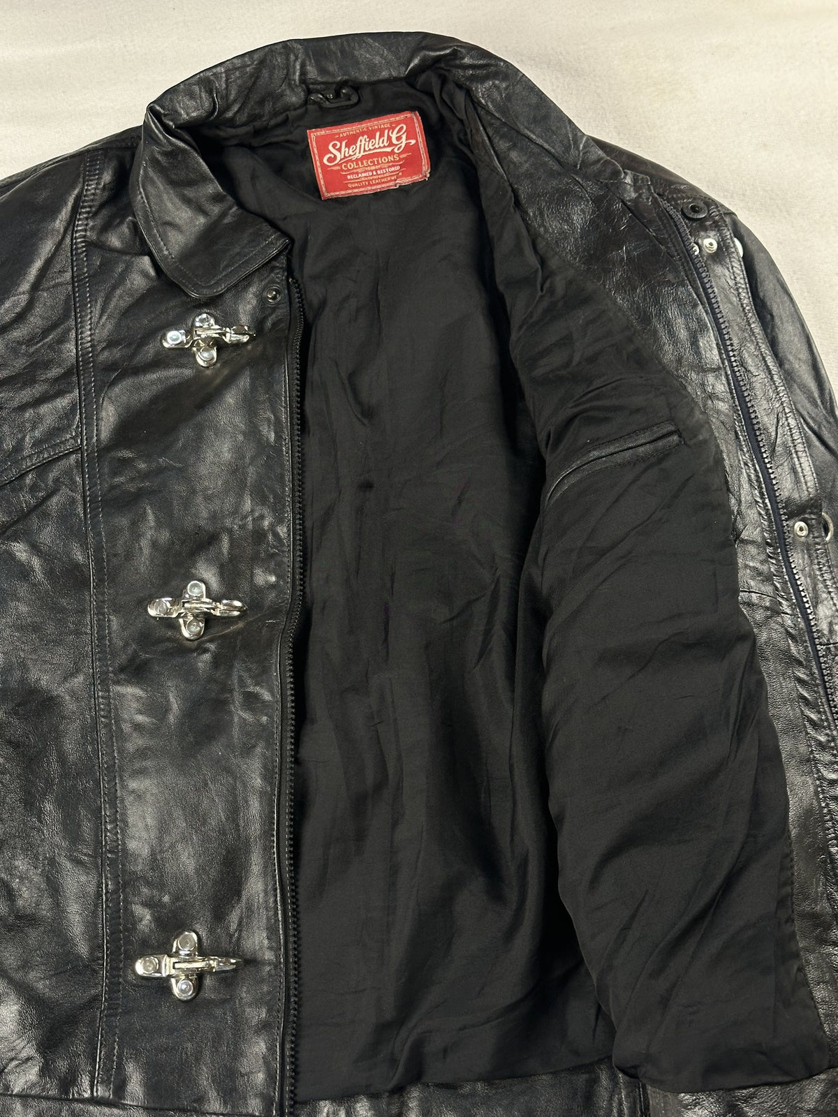 Black leather vintage jacket, size M - cuff and hem detail.