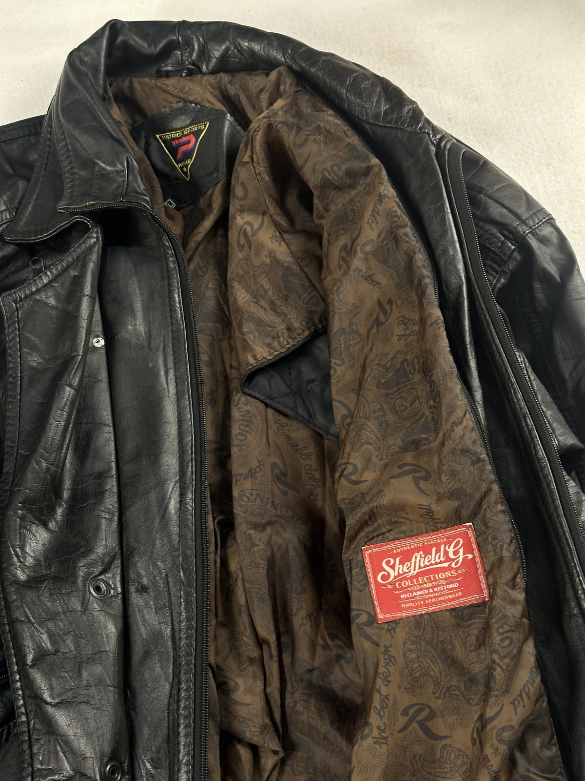 Black leather field jacket, size L - cuff and hem detail.