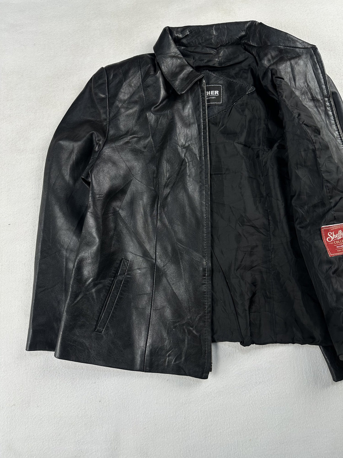 Black leather vintage jacket, size XS - cuff and hem detail.