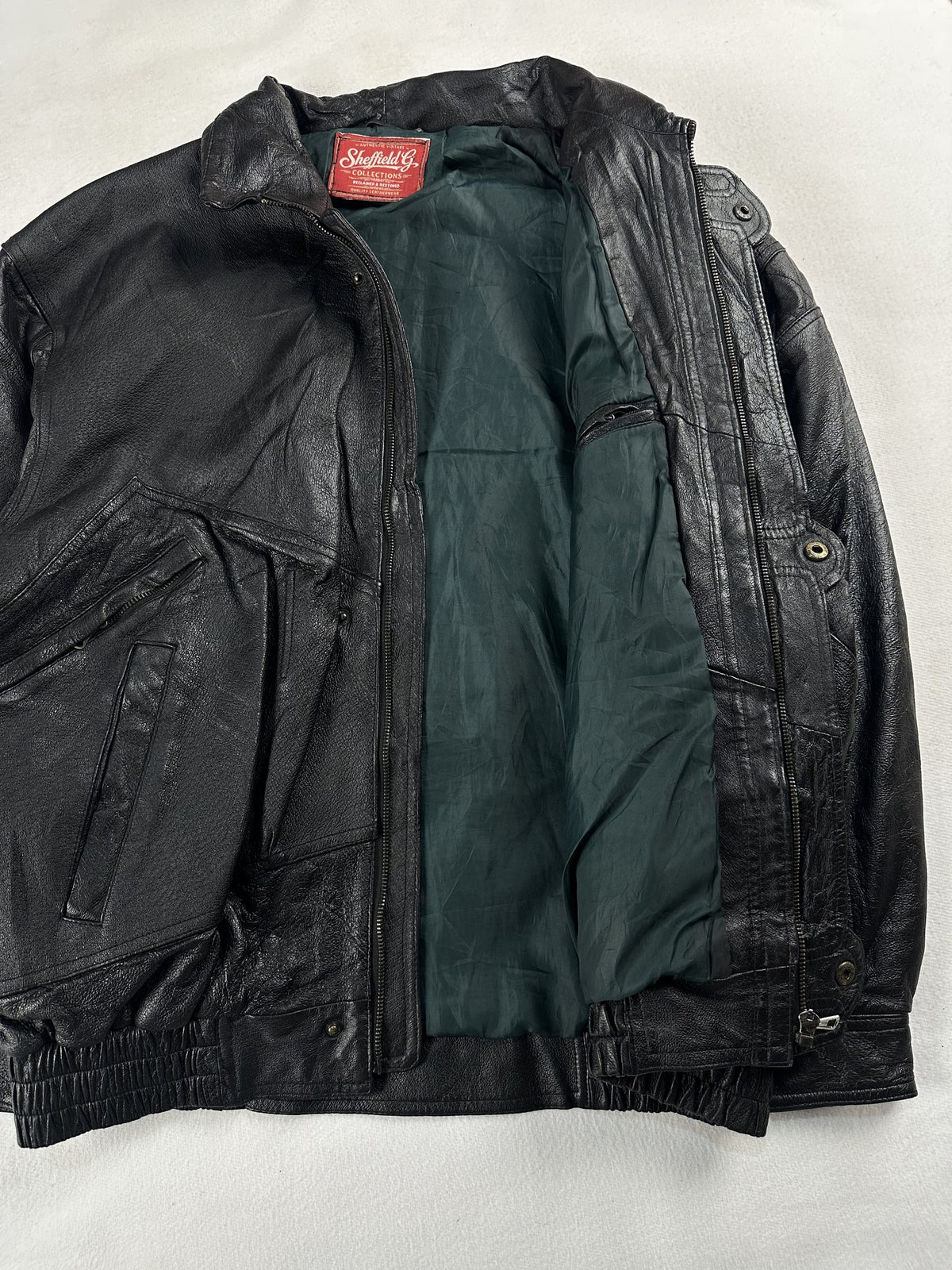 Black leather field jacket, size L - cuff and hem detail.