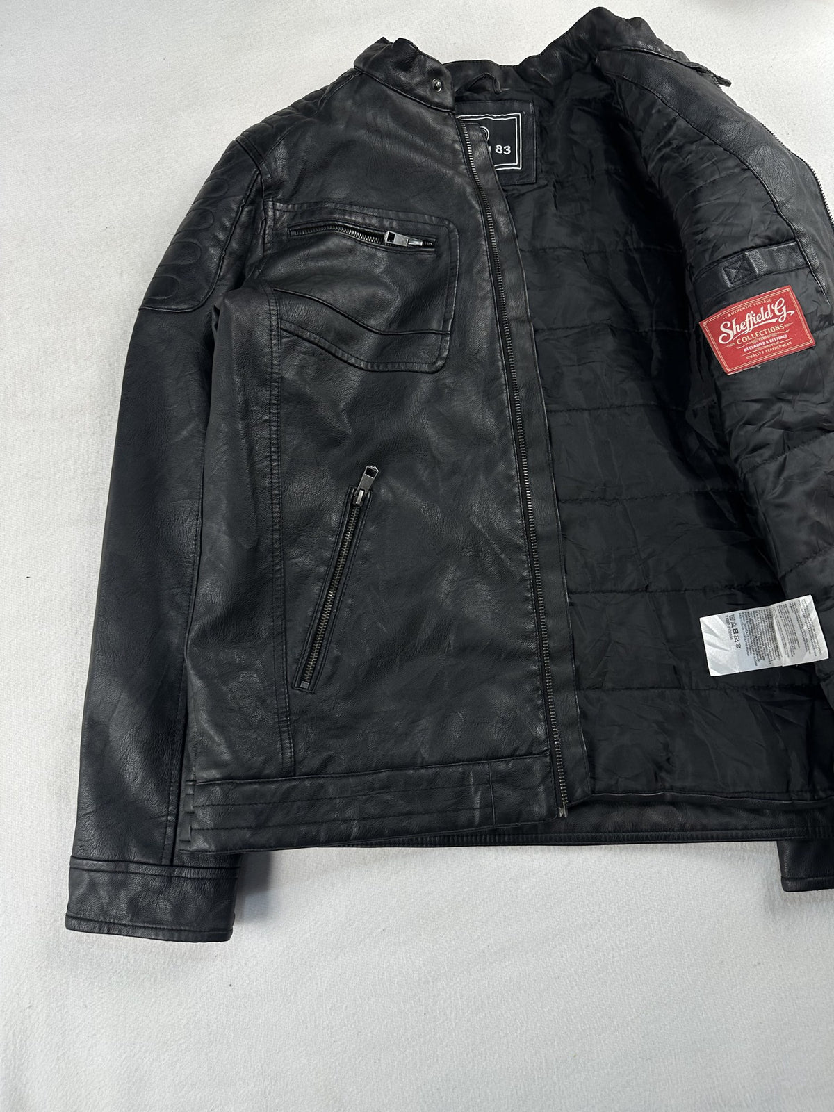 Black leather cafe racer jacket, size M - cuff and hem detail.