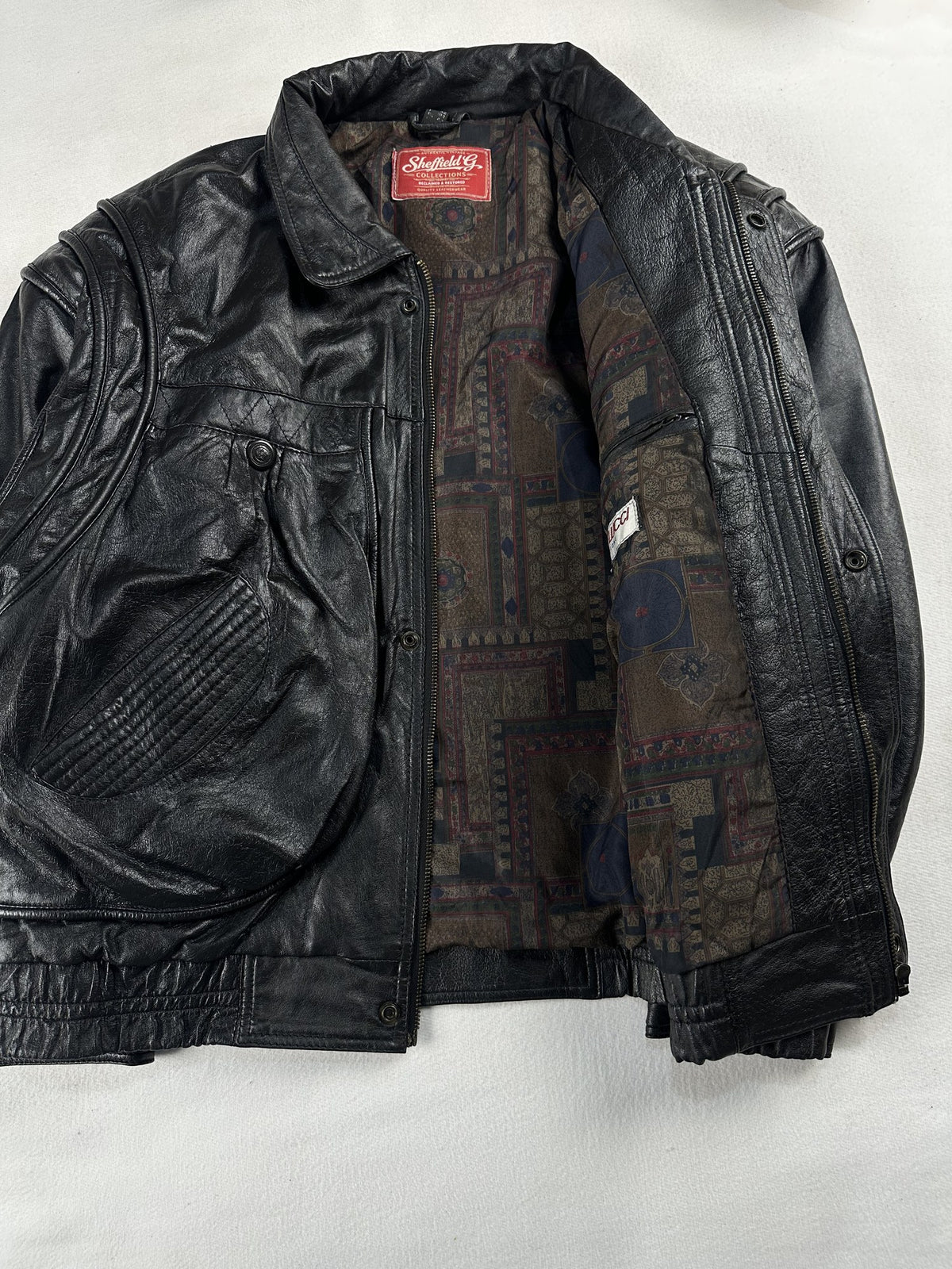 Black leather field jacket, size M - cuff and hem detail.