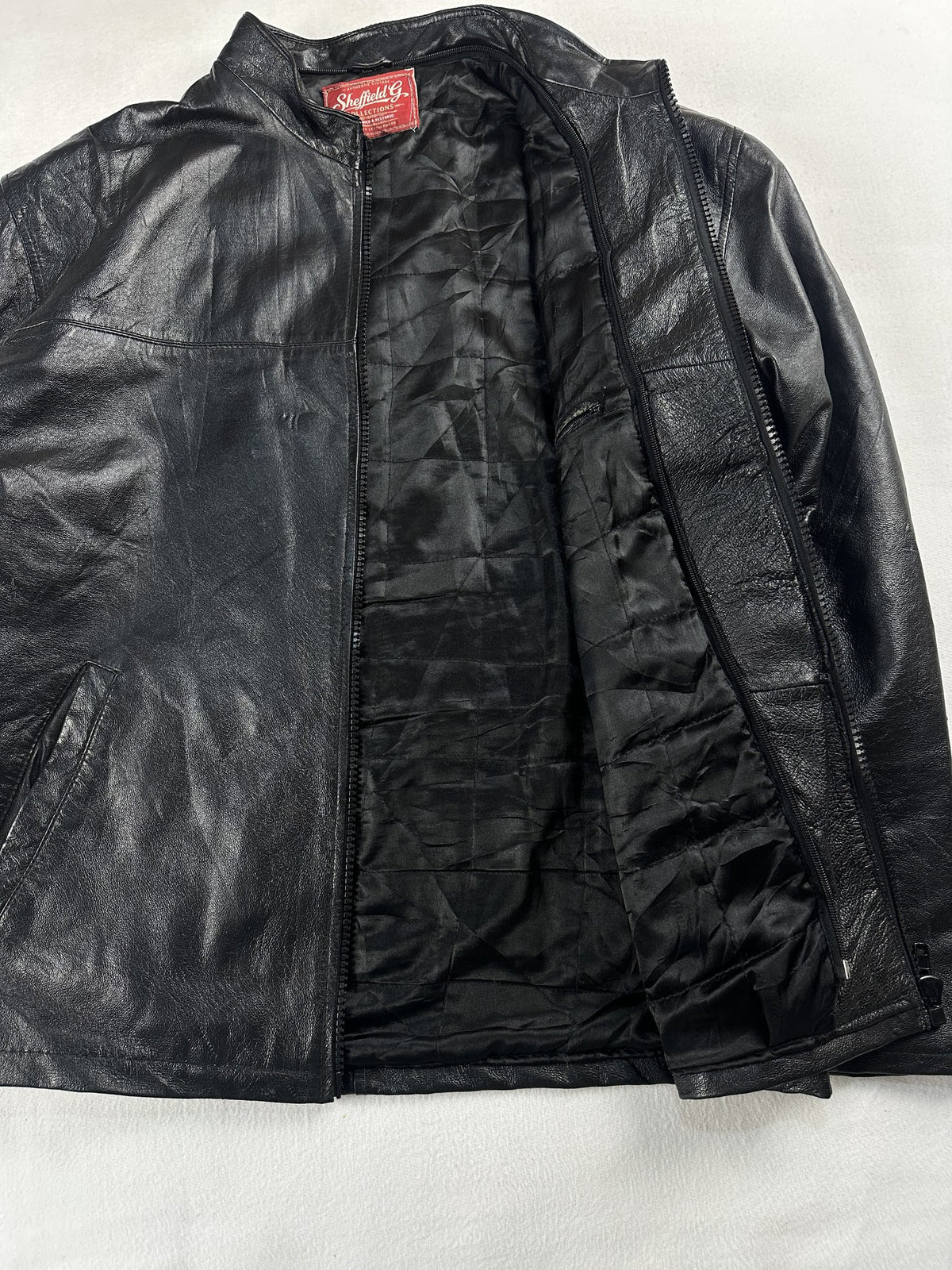 Black leather vintage jacket, size L - cuff and hem detail.