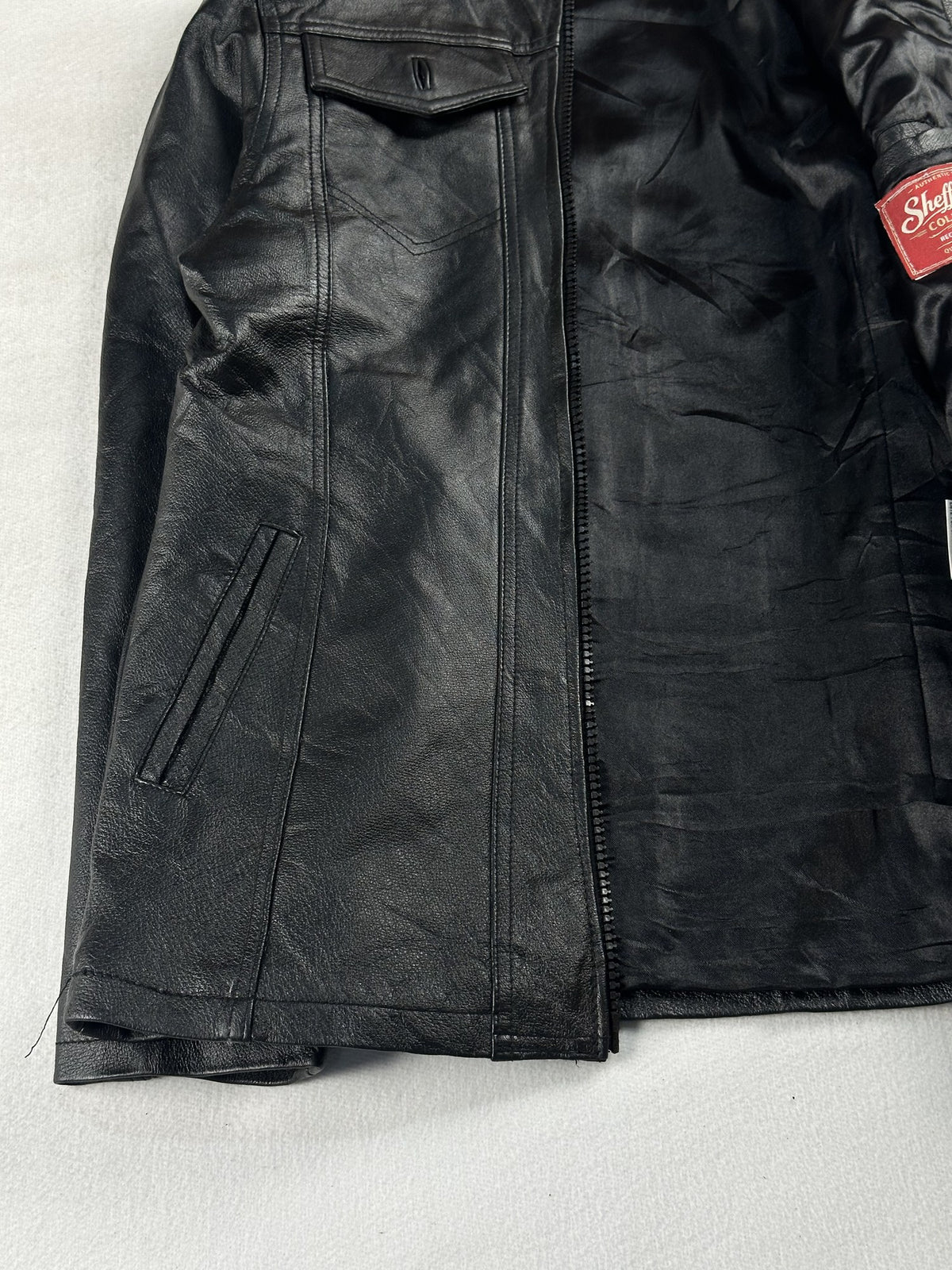 Black leather vintage jacket, size M - cuff and hem detail.