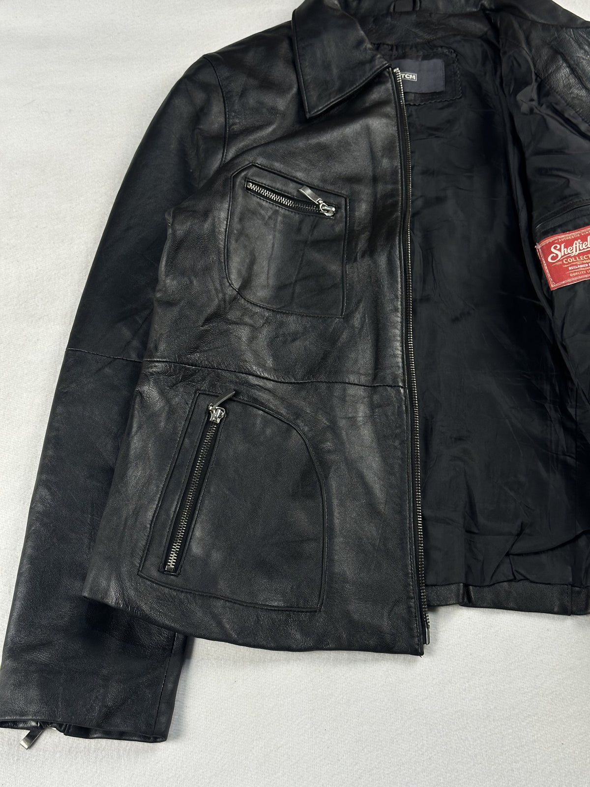 Black leather vintage jacket, size XS - cuff and hem detail.