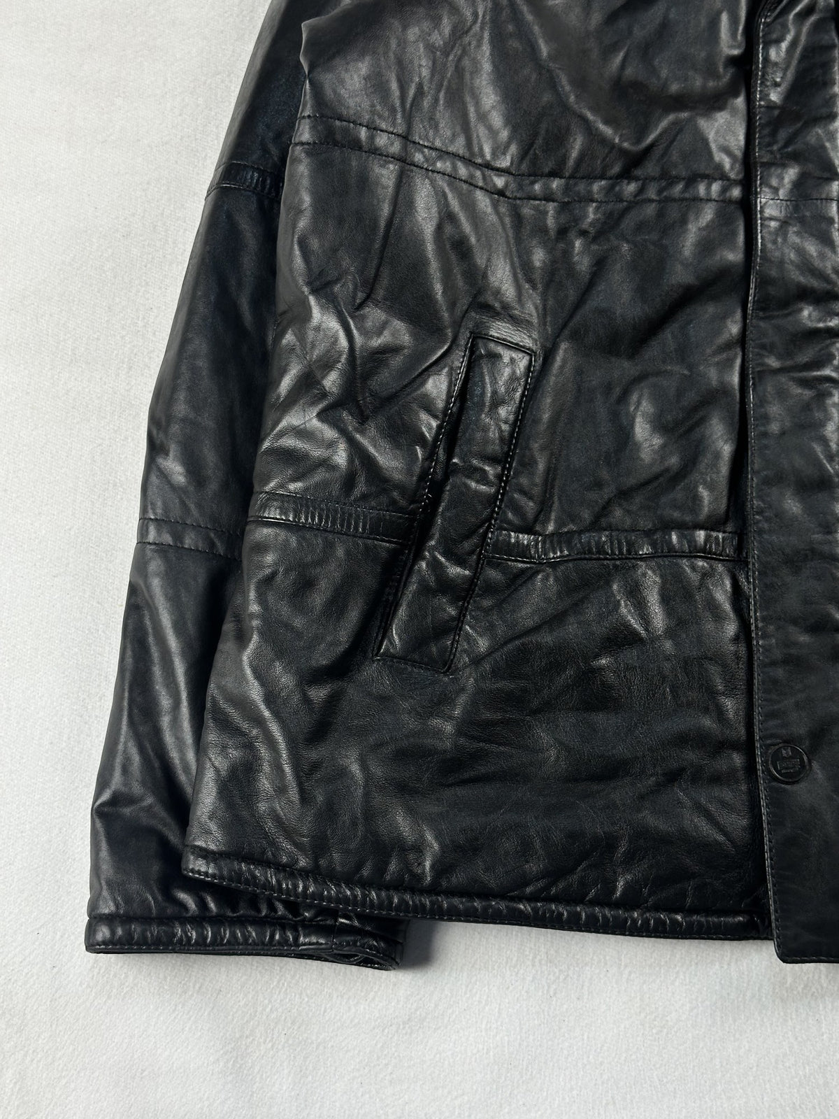 Black leather bomber jacket, size L - chest and pocket detail.