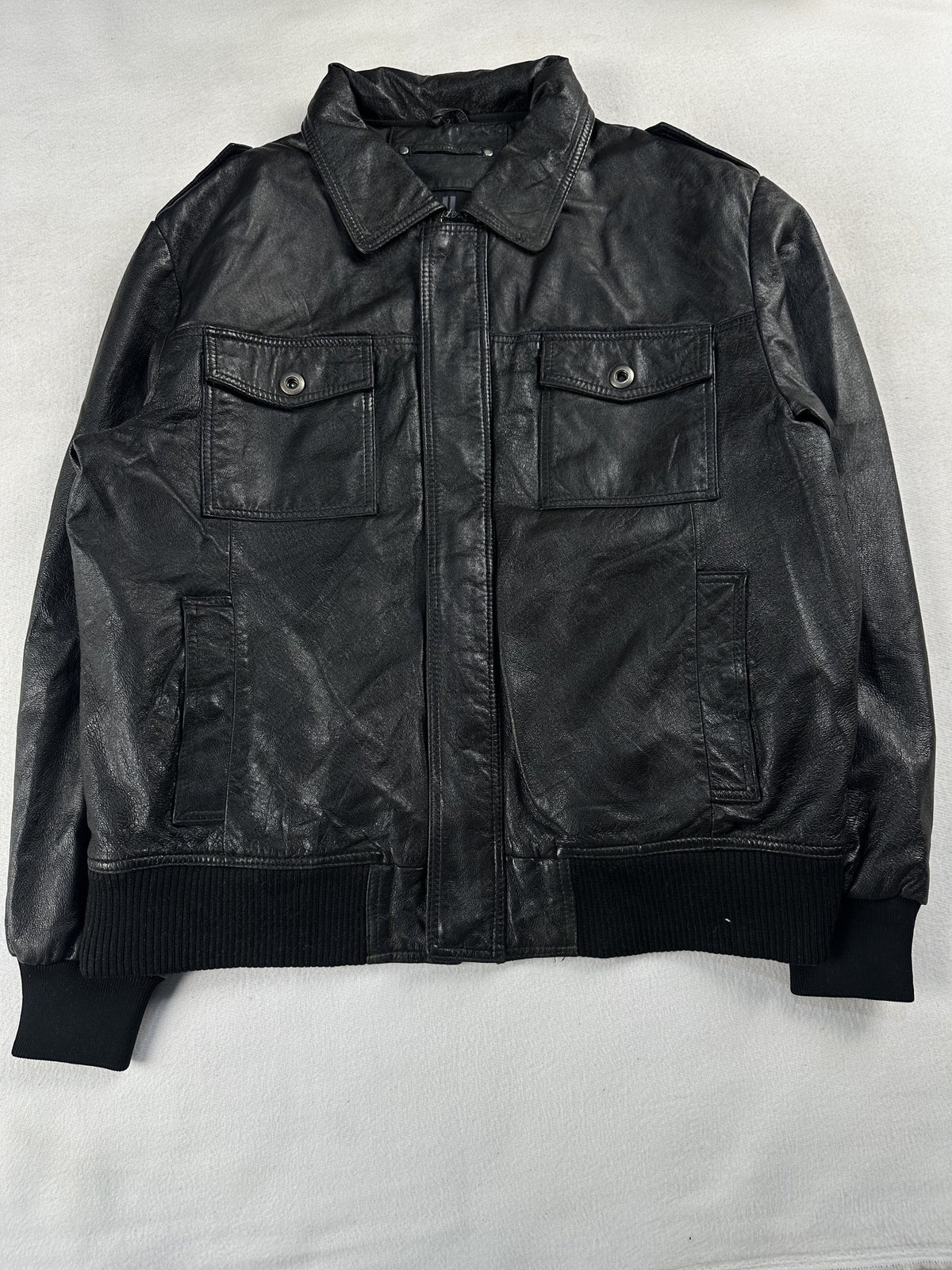 Black leather bomber jacket, size M - chest and pocket detail.