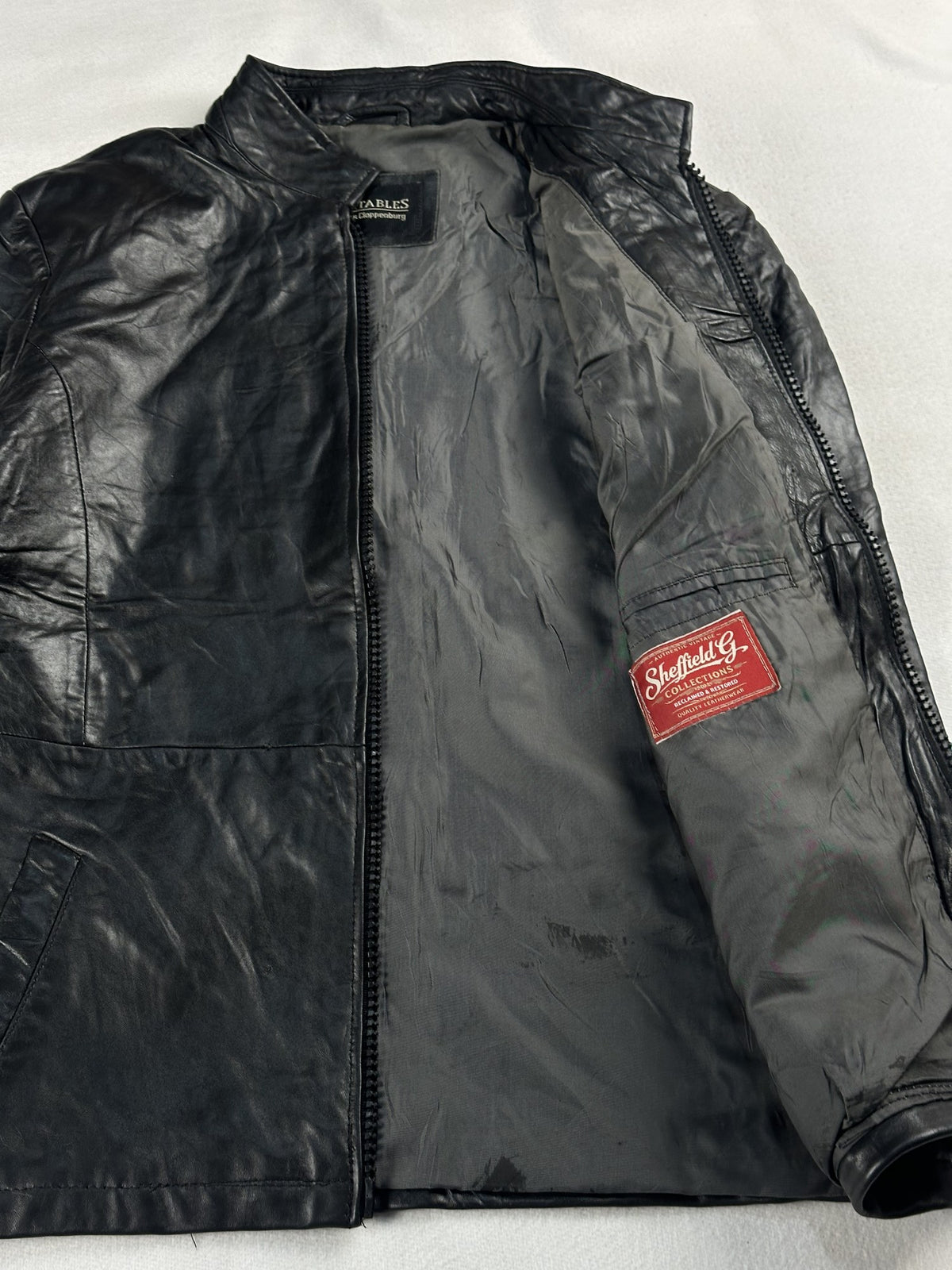 Black leather cafe racer jacket, size M - cuff and hem detail.
