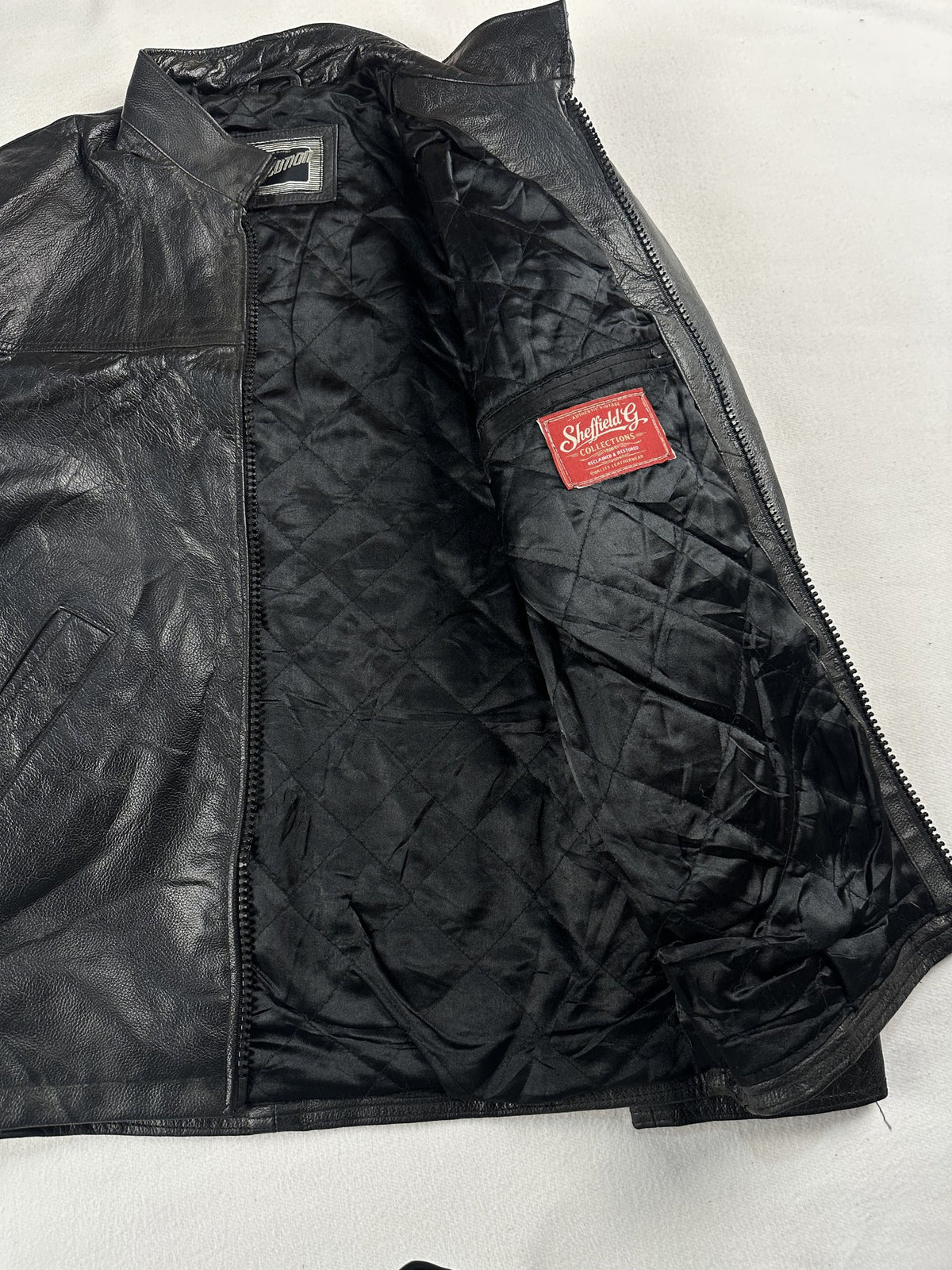 Black leather vintage jacket, size M - cuff and hem detail.