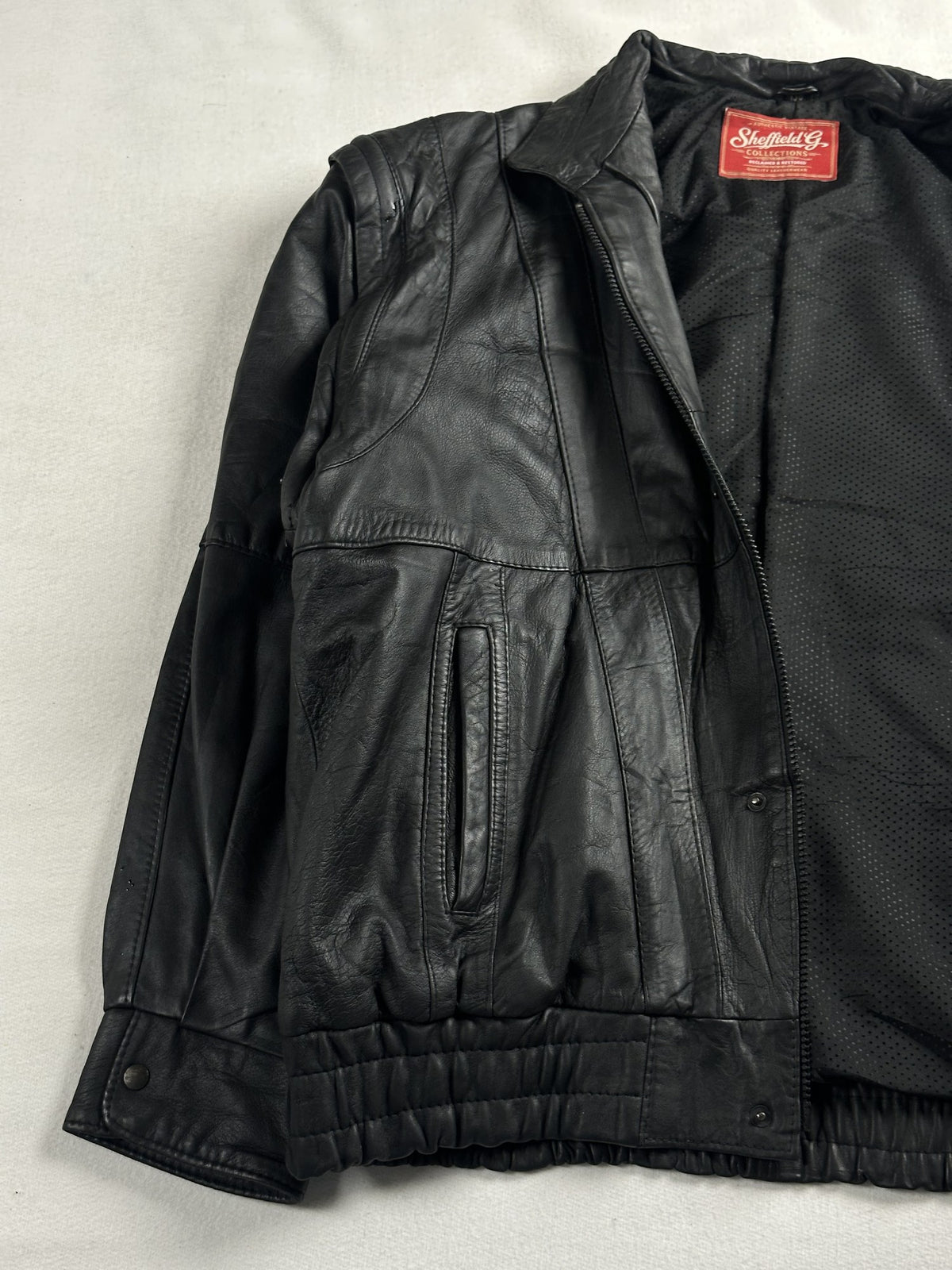 Black leather vintage jacket, size M - cuff and hem detail.