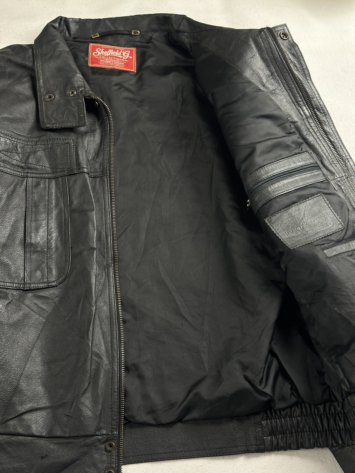 Black leather vintage jacket, size M - cuff and hem detail.