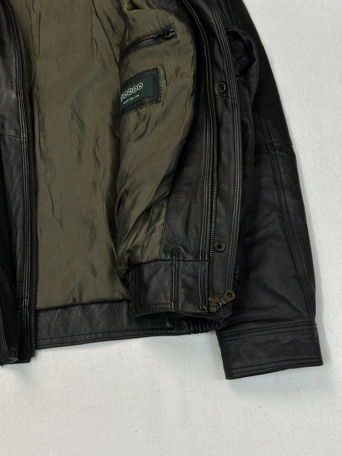 Back panel of the black leather vintage jacket, size L.