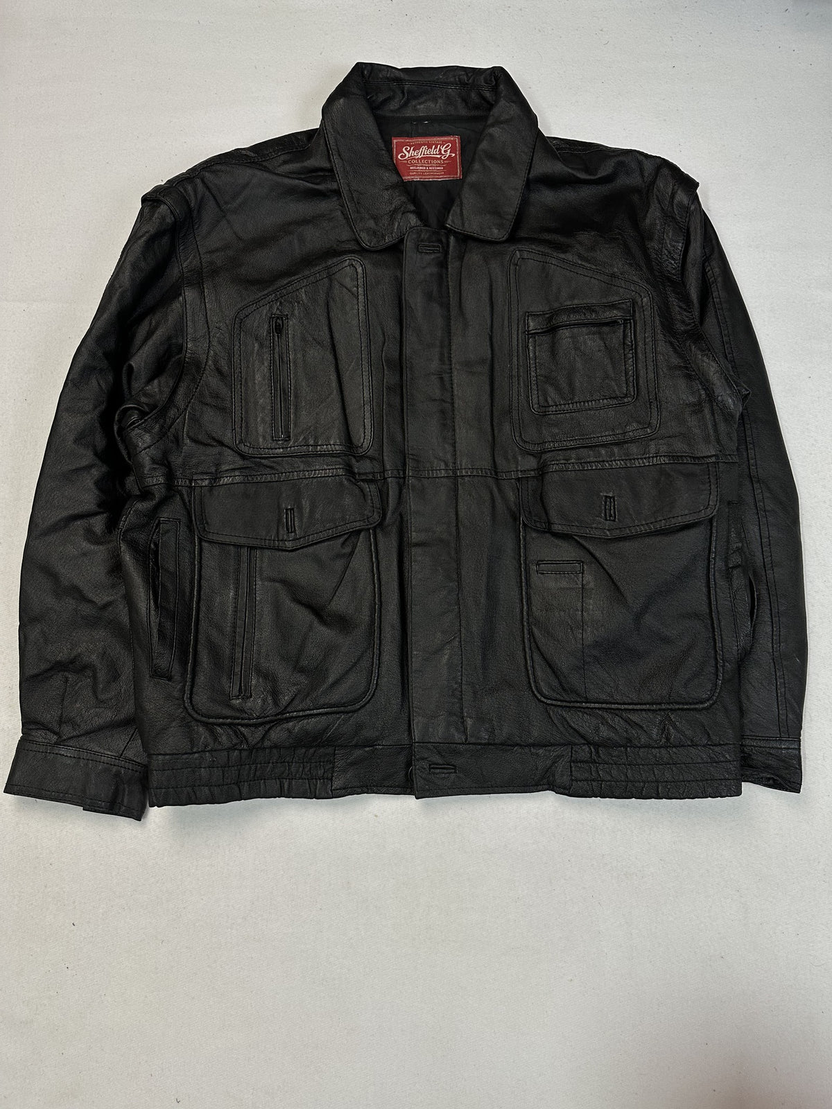Lower flap pockets on the black leather field jacket.