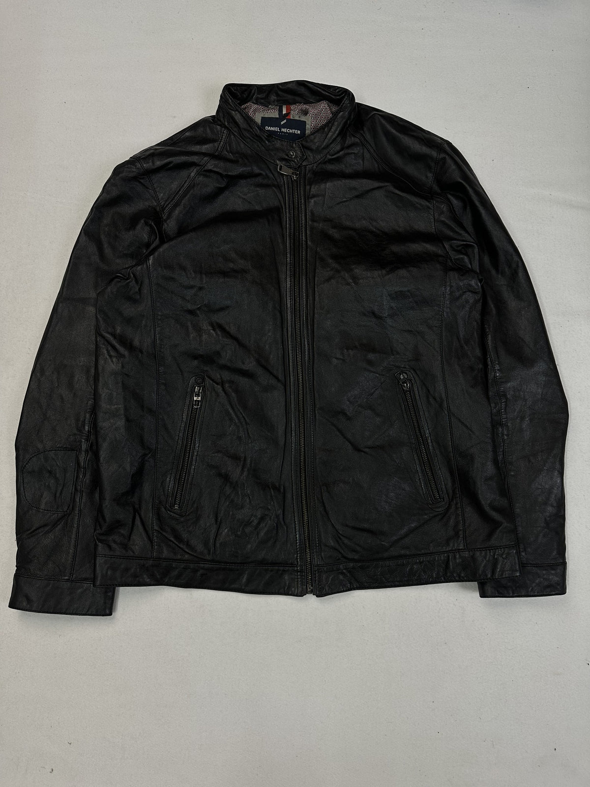 Zip chest pocket on the black leather cafe racer jacket.