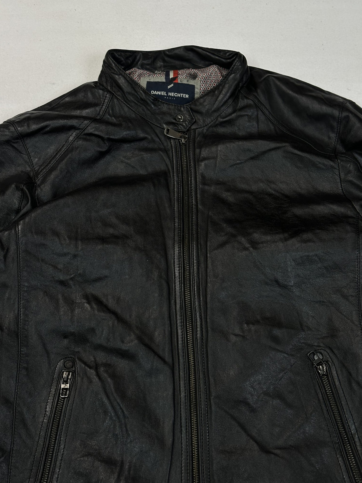 Sleeve and cuff of the black leather cafe racer jacket.