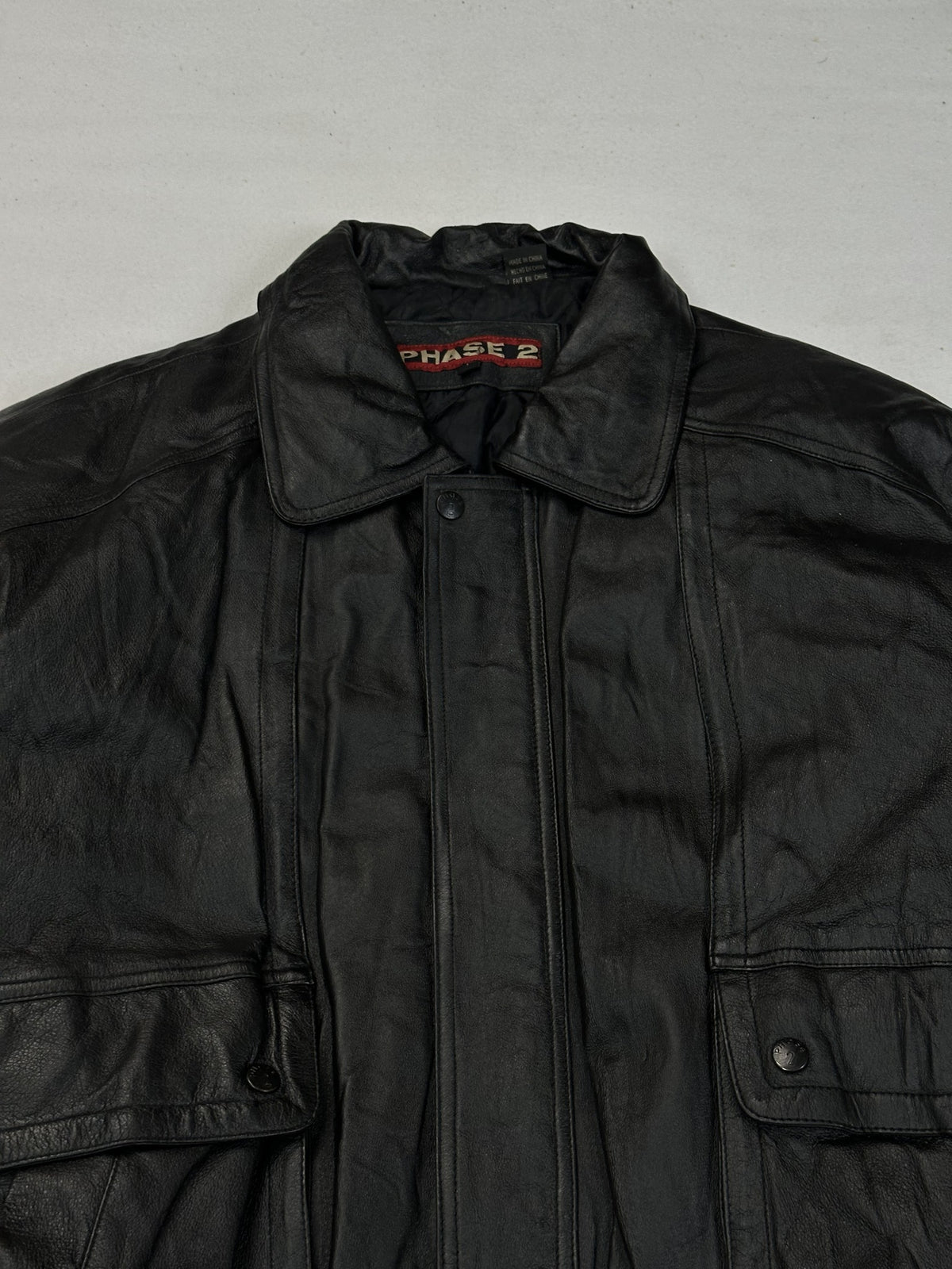 Sleeve of the black leather harrington jacket.