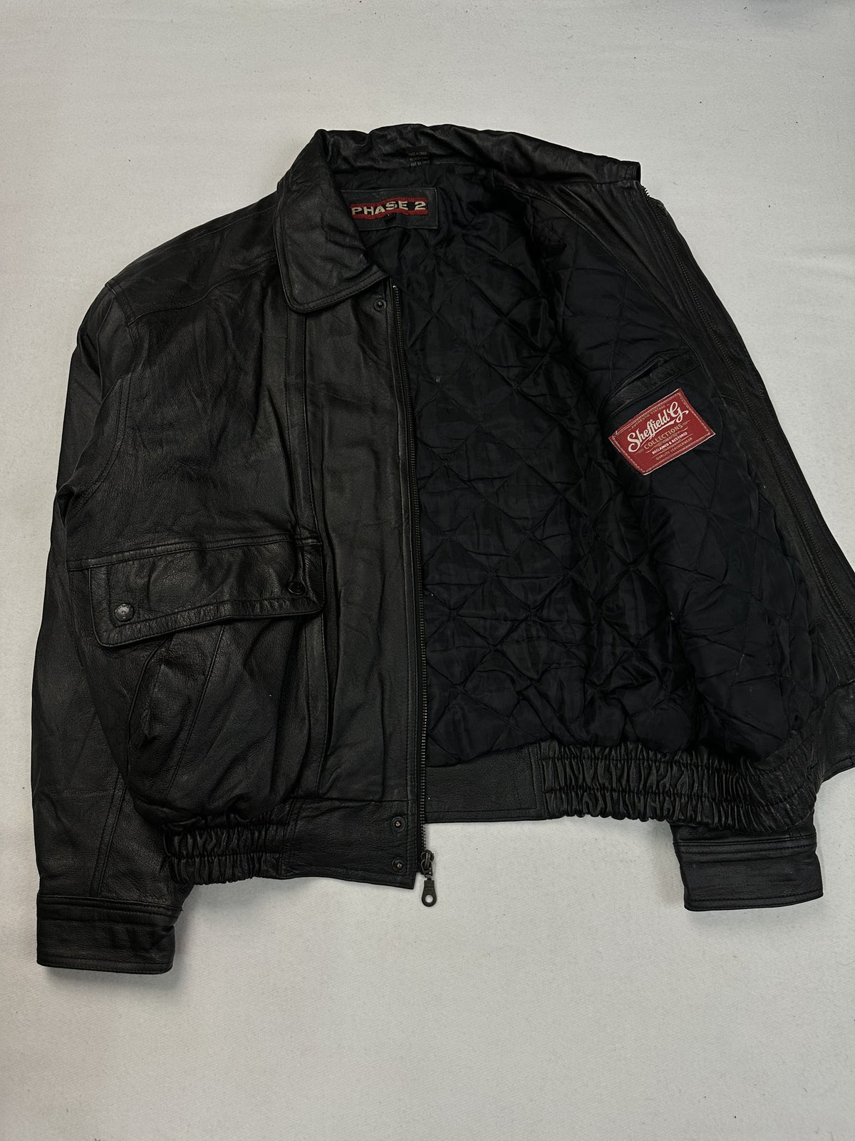 Back panel of the black leather harrington jacket.