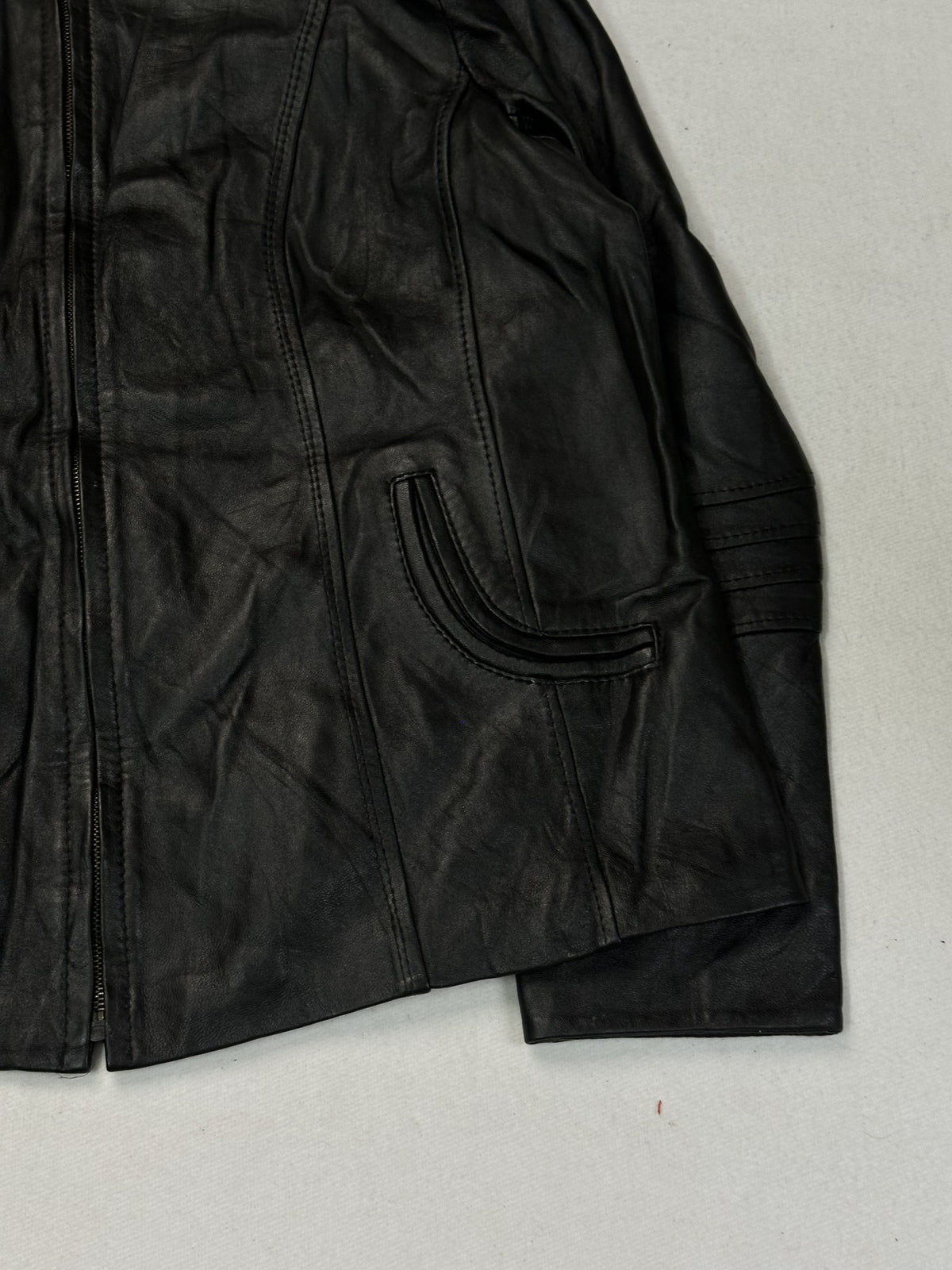 Sleeve of the black leather cafe racer showing decorative arm stitching.