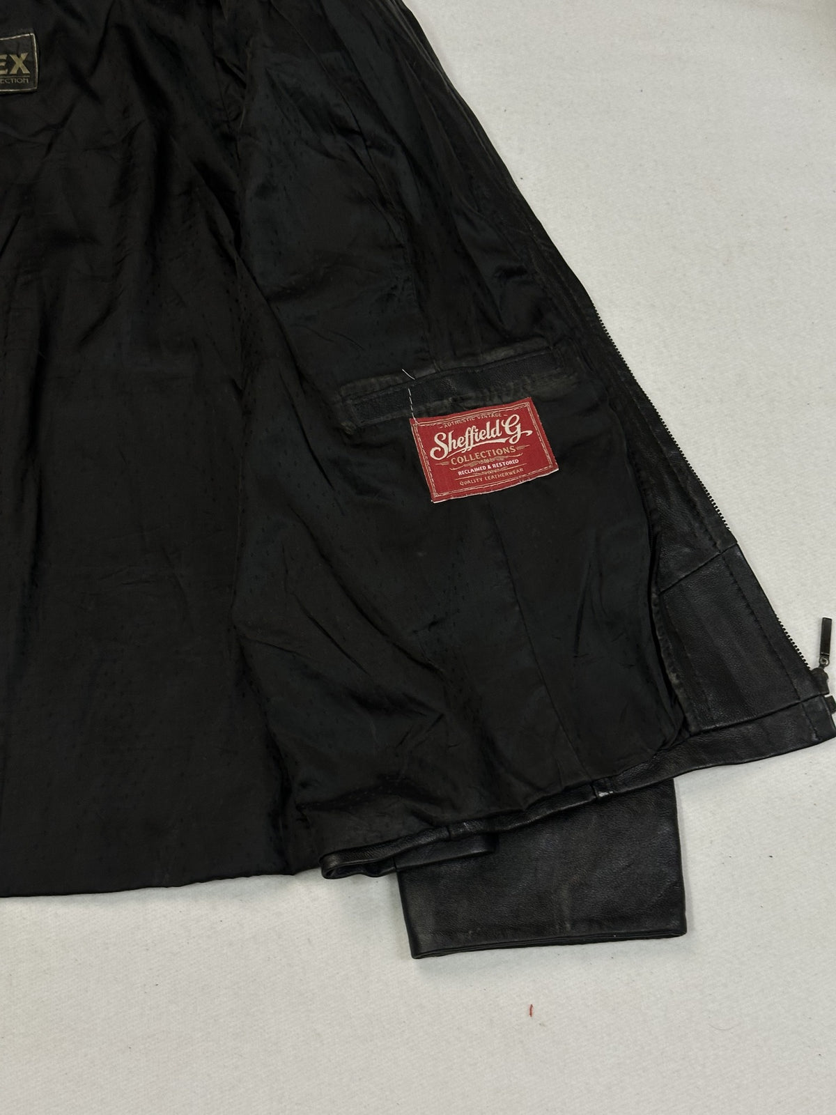 Back panel of the black leather cafe racer jacket.